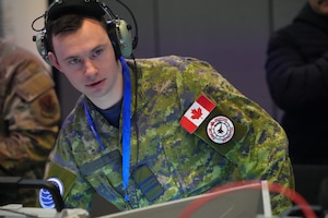 Coalition member wearing headset works on U.S. system