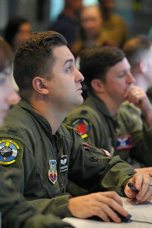 photo of US military members work on computers