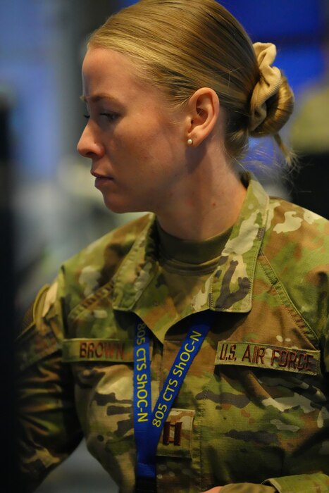 photo of US military member writes on a whiteboard