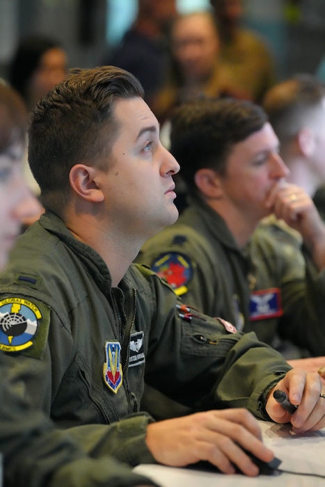 photo of US military members work on computers