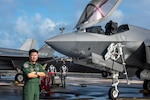 Japan Air Self-Defense Force Col. Takeshi Okubo, flight group commander, 3rd Air Wing, poses for a photo in front of an F-35A Lightning II during exercise Cope North 25 at Andersen Air Force Base, Guam