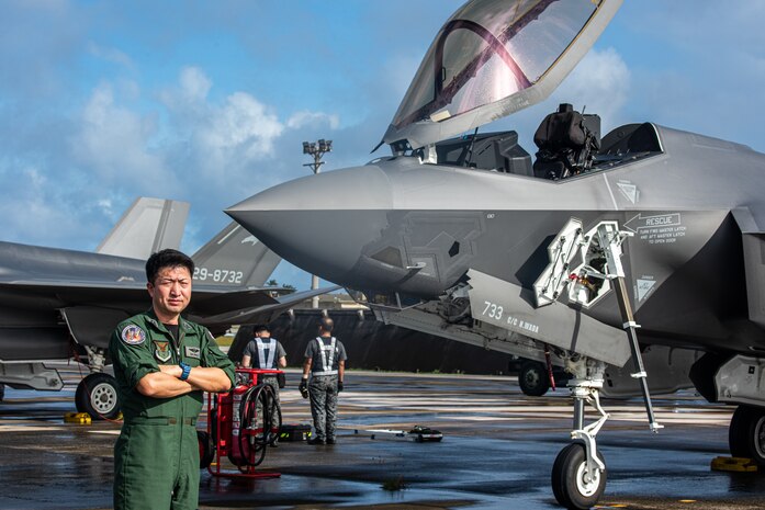 Japan Air Self-Defense Force Col. Takeshi Okubo, flight group commander, 3rd Air Wing, poses for a photo in front of an F-35A Lightning II during exercise Cope North 25 at Andersen Air Force Base, Guam