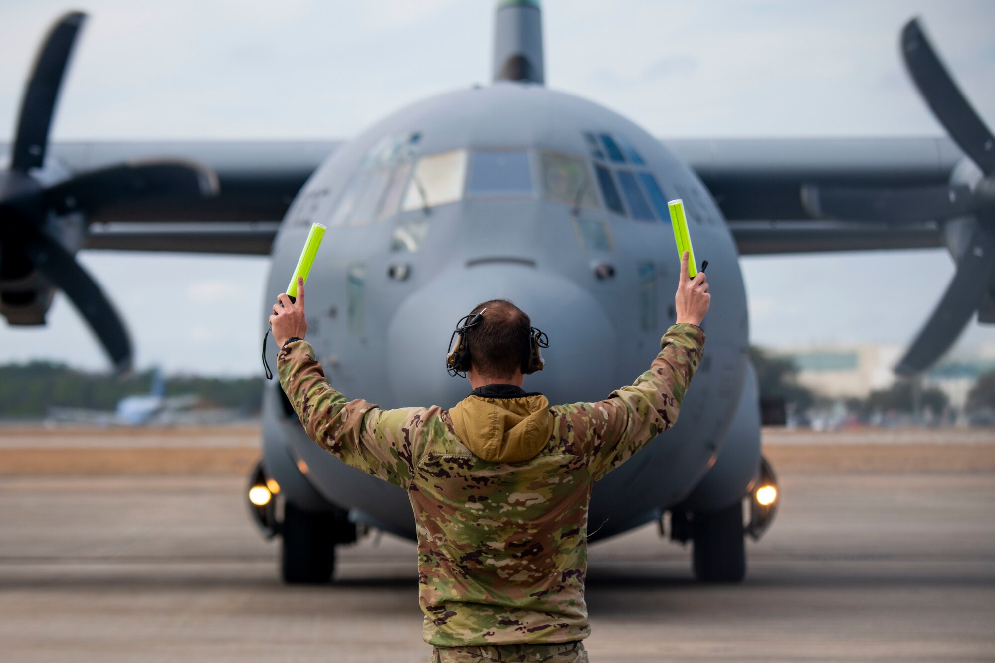 A U.S. Air Force Airman assigned to the 146th Airlift Wing marshals a C-130H Hercules at the Combat Readiness and Training Center, Gulfport, Mississippi, Feb. 5, 2025. Exercise Sentry South-Southern Strike is a joint military training focusing on contingency response operations, agile combat employment, aeromedical evacuation, maritime training, specialized fueling operations and strategic airlift and airdrops.