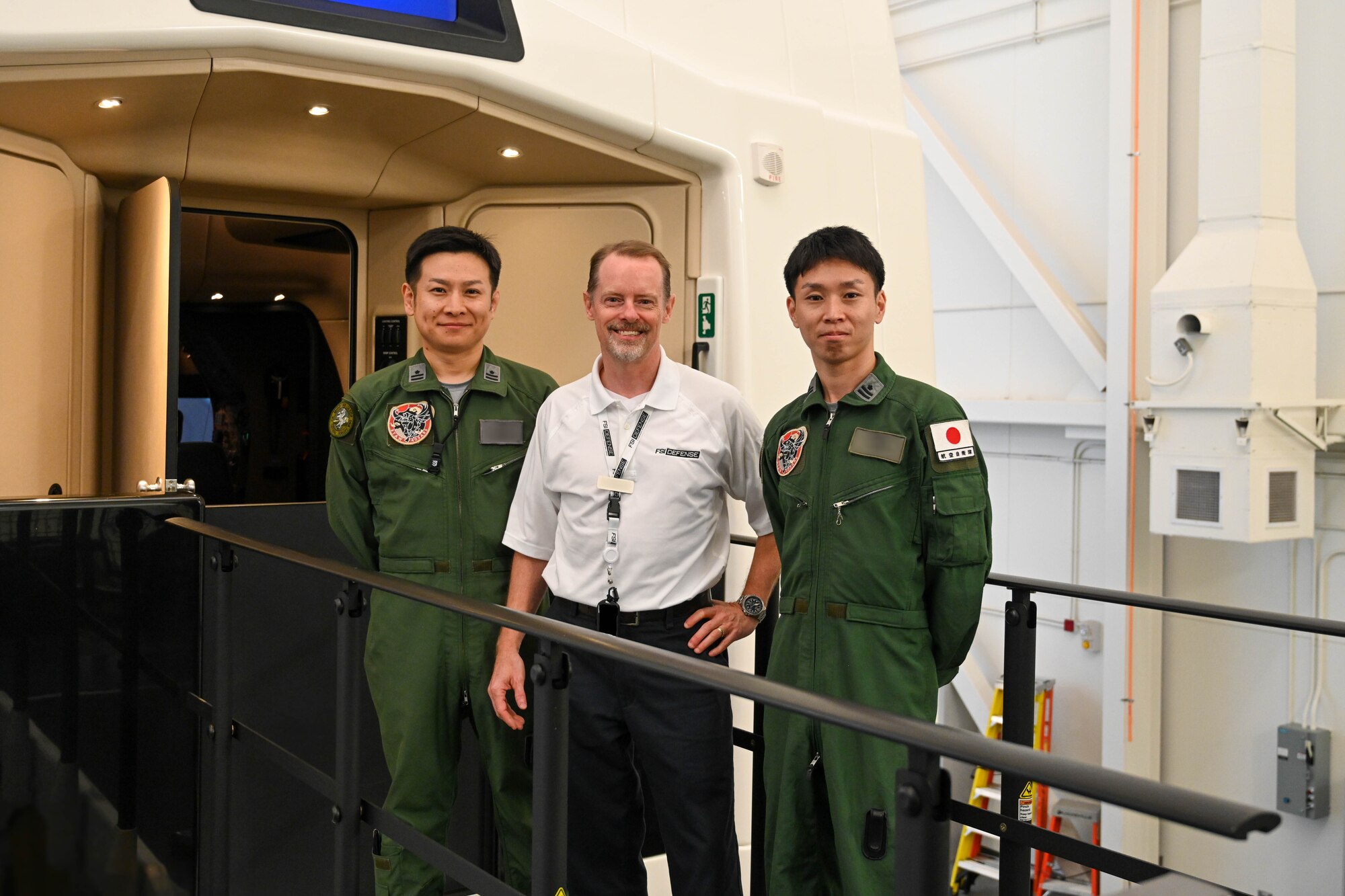Japanese Air Self-Defense Force (JASDF) Maj. Yohei Uramoto, 405th Air Refueling Squadron KC-46 Pegasus aircraft pilot (left), Nicola Borghini, Flight Safety International KC-46 lead pilot instructor (center), and JASDF Maj. Yoshiaki Fujii, 405th Air Refueling Squadron KC-46 pilot (right) poses for a photo at Altus Air Force Base, Oklahoma, Nov. 6, 2024. The KC-46 has been in development since 2011 and represents the beginning of a new era in air-to-air refueling capability for the joint force. (U.S. Air Force photo by Airman 1st Class Lauren Torres) (This photo has been altered for security purposes by blurring out identification badges)