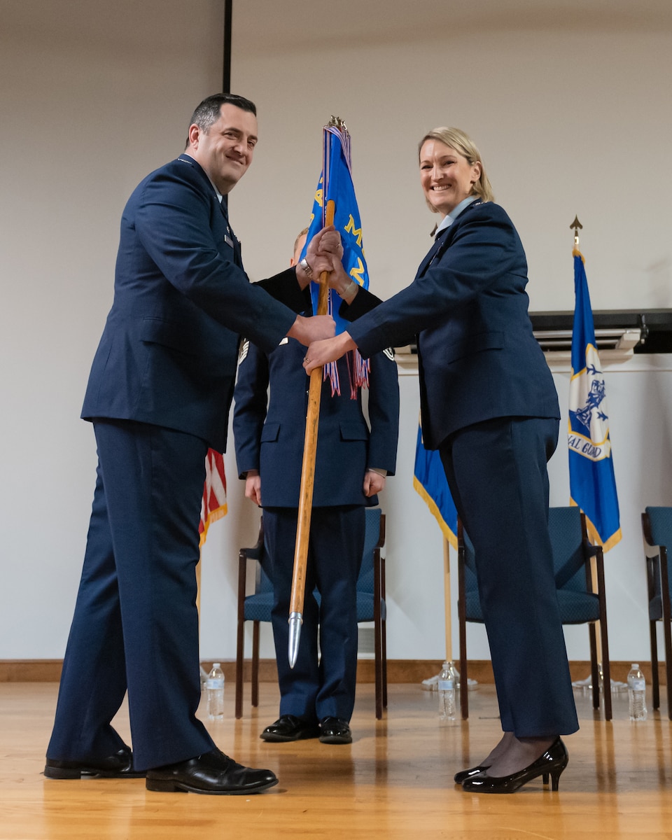 Col. Patricia Adams, right, assumes command of the 123rd Medical Group as she accepts the unit guidon from Col. Matthew Quenichet, commander of the 123rd Airlift Wing, during a change-of-command ceremony at the Kentucky Air National Guard Base in Louisville, Ky., Dec. 15, 2024. Adams previously served as the group’s deputy commander. (U.S. Air National Guard photo by Tech. Sgt. Chloe Ochs)