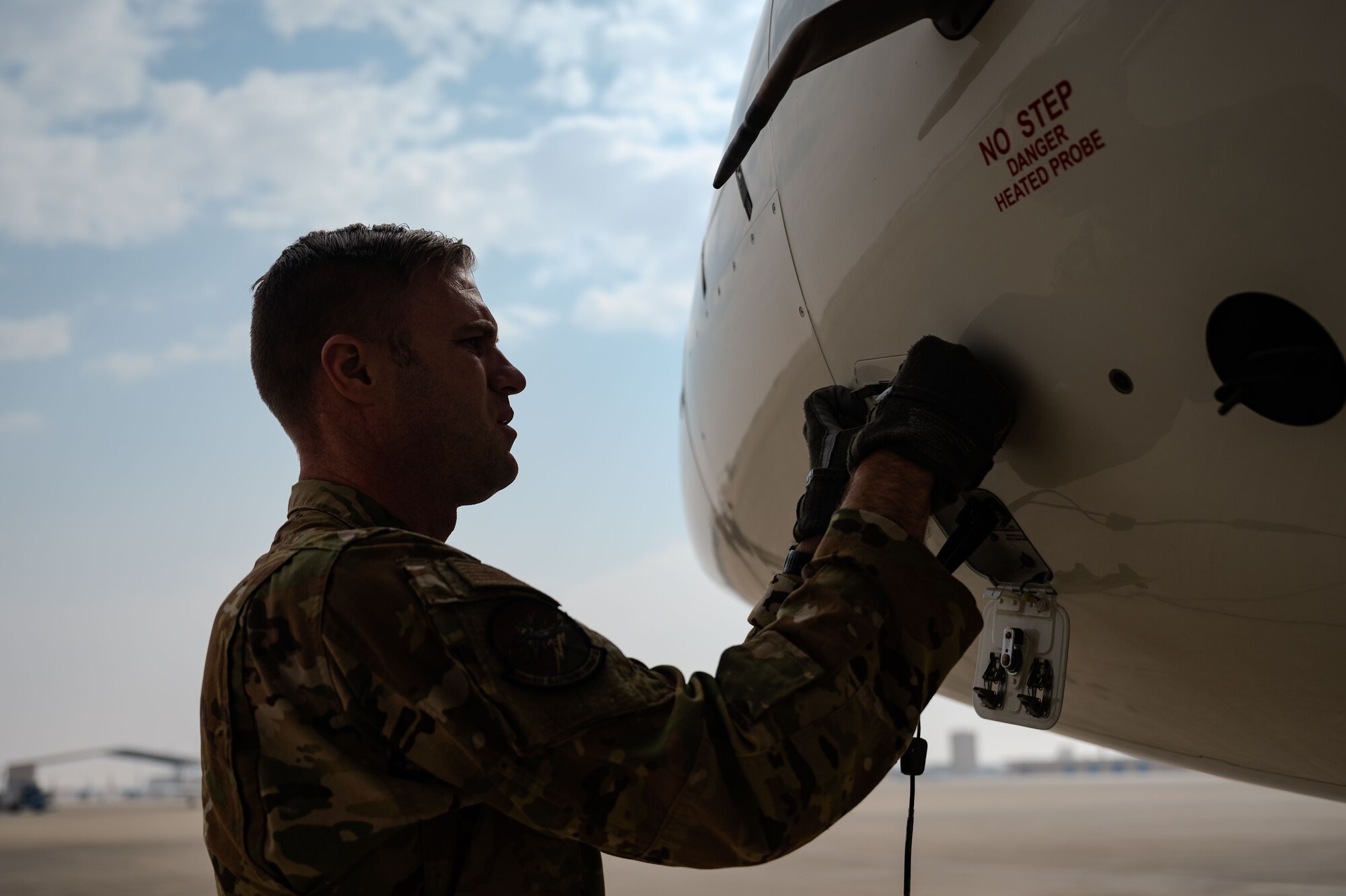 U.S. Air Force Maj. Eric Goodman, a 430th Expeditionary Electronic Combat Squadron E-11A pilot, performs preflight checks before a memorial flight in the U.S. Central Command area of responsibility, Jan. 27, 2025, marking the 5th anniversary of an E-11A crash that claimed the lives of two 430th EECS pilots.
