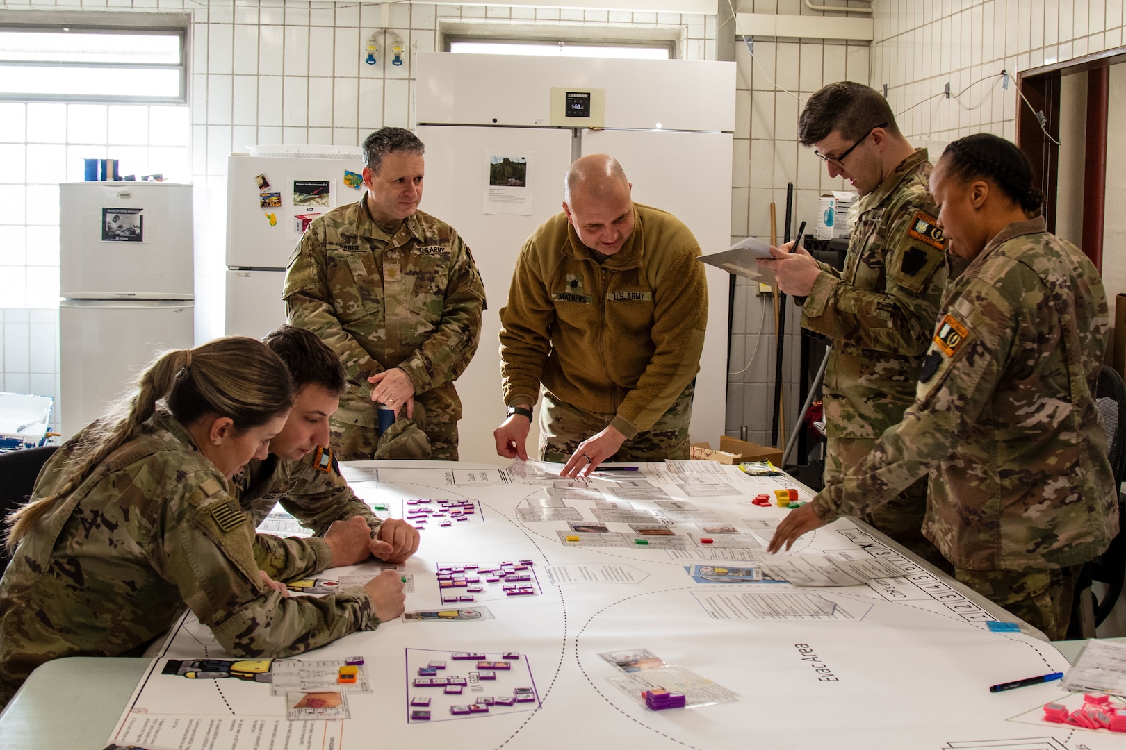 U.S. Soldiers with the Headquarters and Headquarters Company, 56th Stryker Brigade Combat Team, 28th Infantry Division, Pennsylvania National Guard in support of the Joint Multinational Training Group-Ukraine mission play through the role of medics providing treatment during a mass casualty triage wargame exercise at Grafenwoehr Training Area, Germany, Jan. 22, 2025.  The wargame addresses casualty care triage in a large-scale combat operations environment.