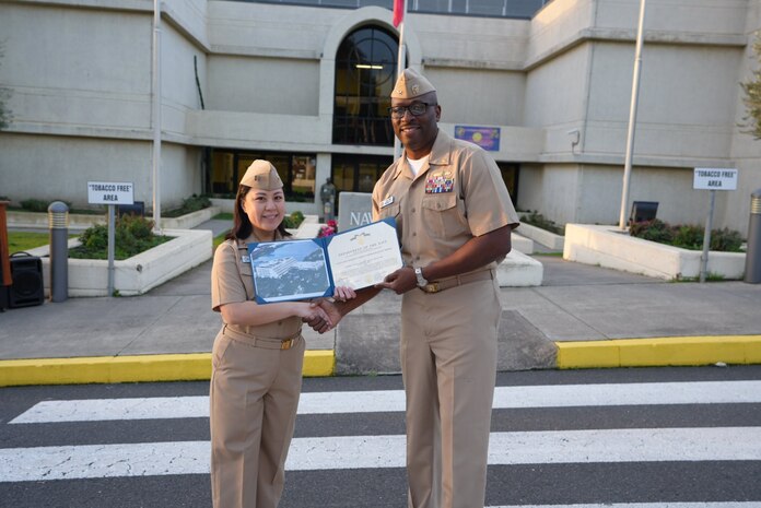 Captain TaRail A. Vernon presents Lieutenant Alyssa Rodriguez with the Navy and Marine Corps Commendation Medal- 1st Award