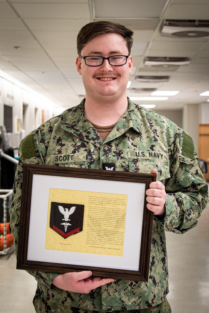 Staff serving aboard Naval Health Clinic Cherry Point celebrated the promotion of Hospital Corpsman Third Class Jacob Scott with a “Tacking of the Crow” ceremony on Friday, February 7.  Scott serves aboard the facility in the Physical Therapy Department.