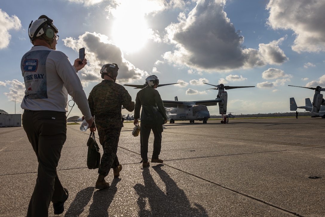 U.S. Marine Corps Sgt. Mark Hanna, a crew chief with Marine Medium Tiltrotor Squadron (VMM) 764, Marine Aircraft Group 41, 4th Marine Aircraft Wing, escorts members of the media onto a flightline, Naval Air Station Joint Reserve Base New Orleans, Belle Chasse, Louisiana, Feb. 7, 2025. The Marine Corps is the lead service for Super Bowl LIX flyover, participating in multiple events throughout the week exhibiting pride leading up to the U.S. Marine Corps 250th birthday. (U.S. Marine Corps photo by Sgt. Scott Jenkins)