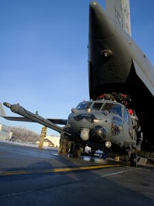 Maintenance Airmen of 176th Maintenance Group and 176th Logistics Readiness Squadron Aerial Port Airmen unload a 210th Rescue Squadron HH-60G Pave Hawk from a 144th Airlift Squadron C-17 Globemaster III Feb. 6, 2025, at Joint Base Elmendorf-Richardson, Alaska. The HH-60’s crew and 212th Rescue Squadron pararescuemen rescued two victims of a Jan. 26 ultralight plane crash near Faro, Yukon Territory, Canada.