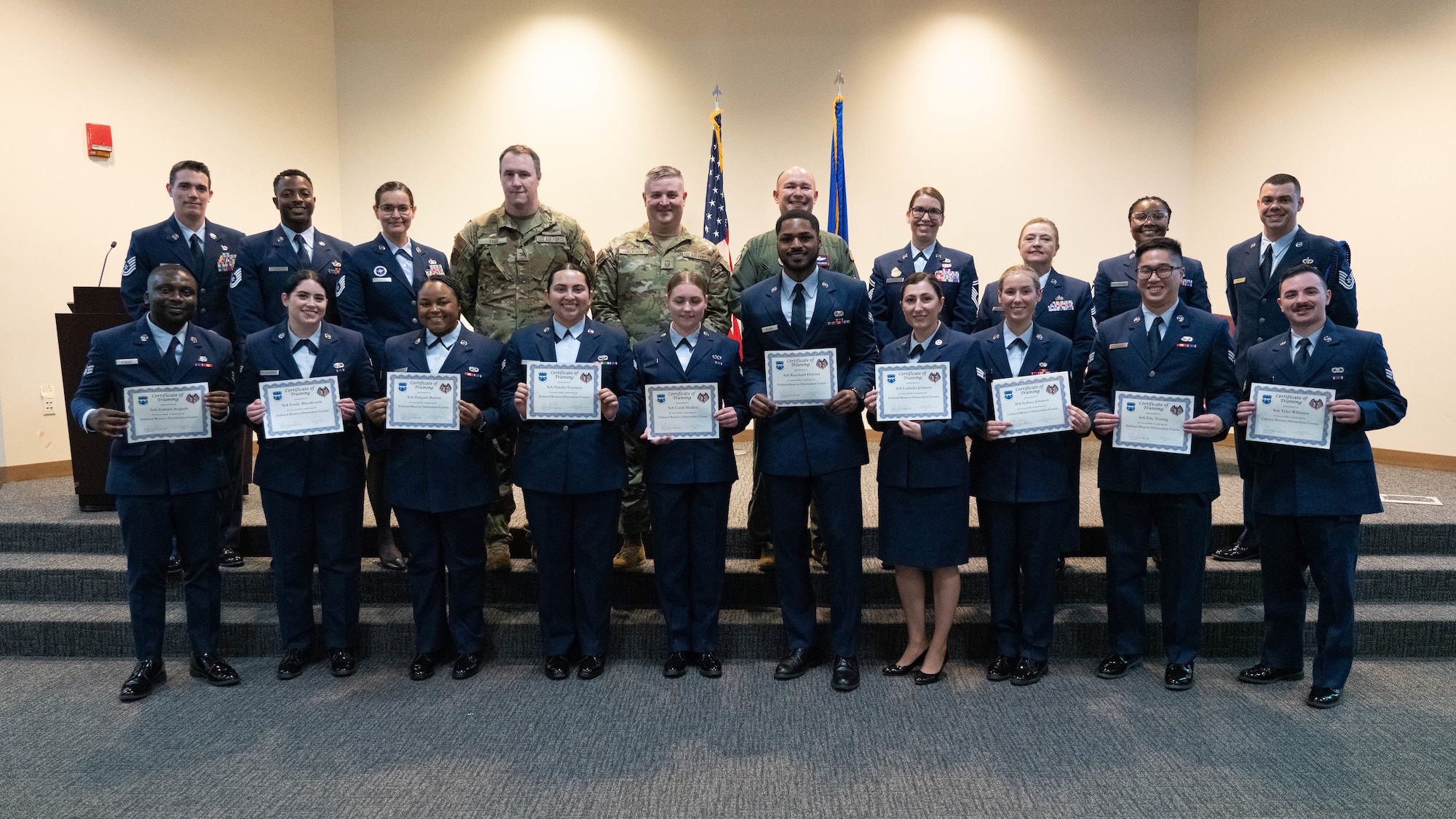 Airmen are holding certificates in graduation photo