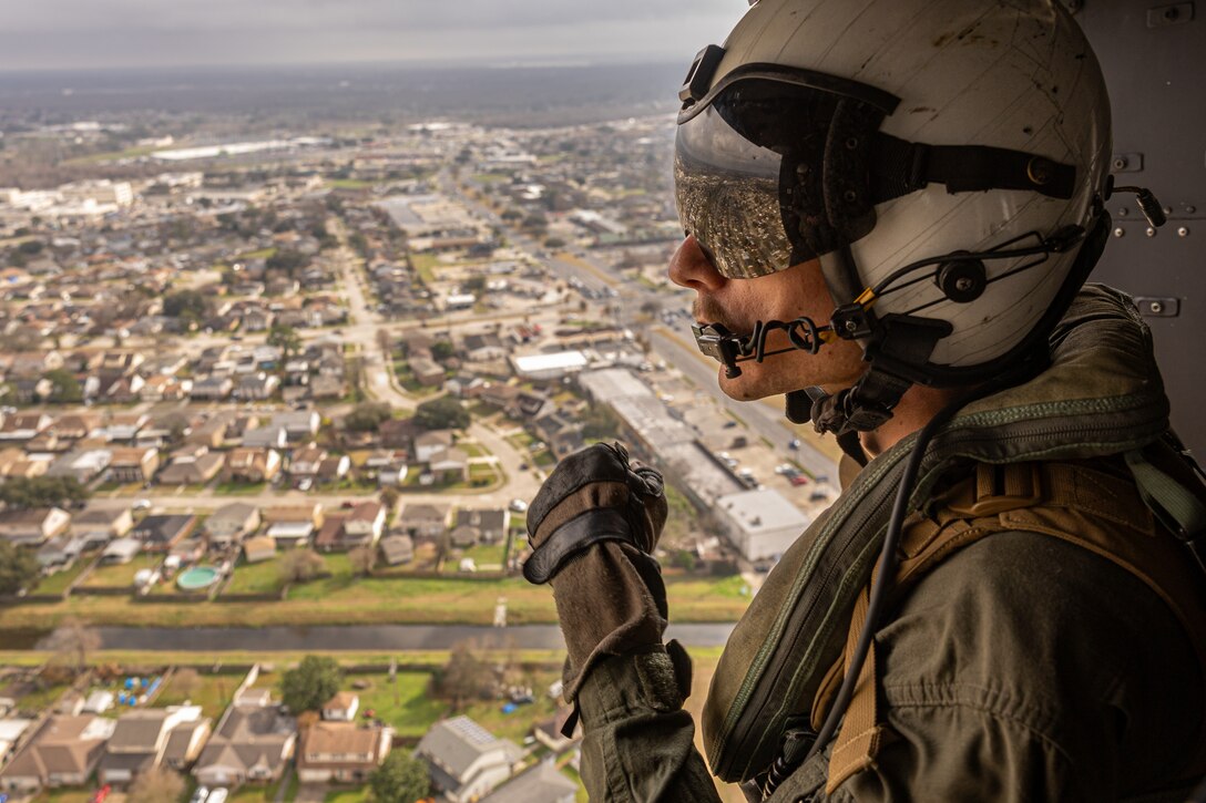 U.S. Marine Corps Cpl. Ryan Helmstetter, helicopter crew chief with Light Attack Helicopter Squadron (HMLA) 773, Marine Air Group 49, 4th Marine Aircraft Wing, participates in a flyover for the Super Bowl LIX parade, New Orleans, Feb. 8, 2025. The Marine Corps is the lead service for Super Bowl LIX, participating in multiple events throughout the week exhibiting pride leading up to the U.S. Marine Corps' 250th birthday. (U.S. Marine Corps photo by Cpl. Aaron TorresLemus)