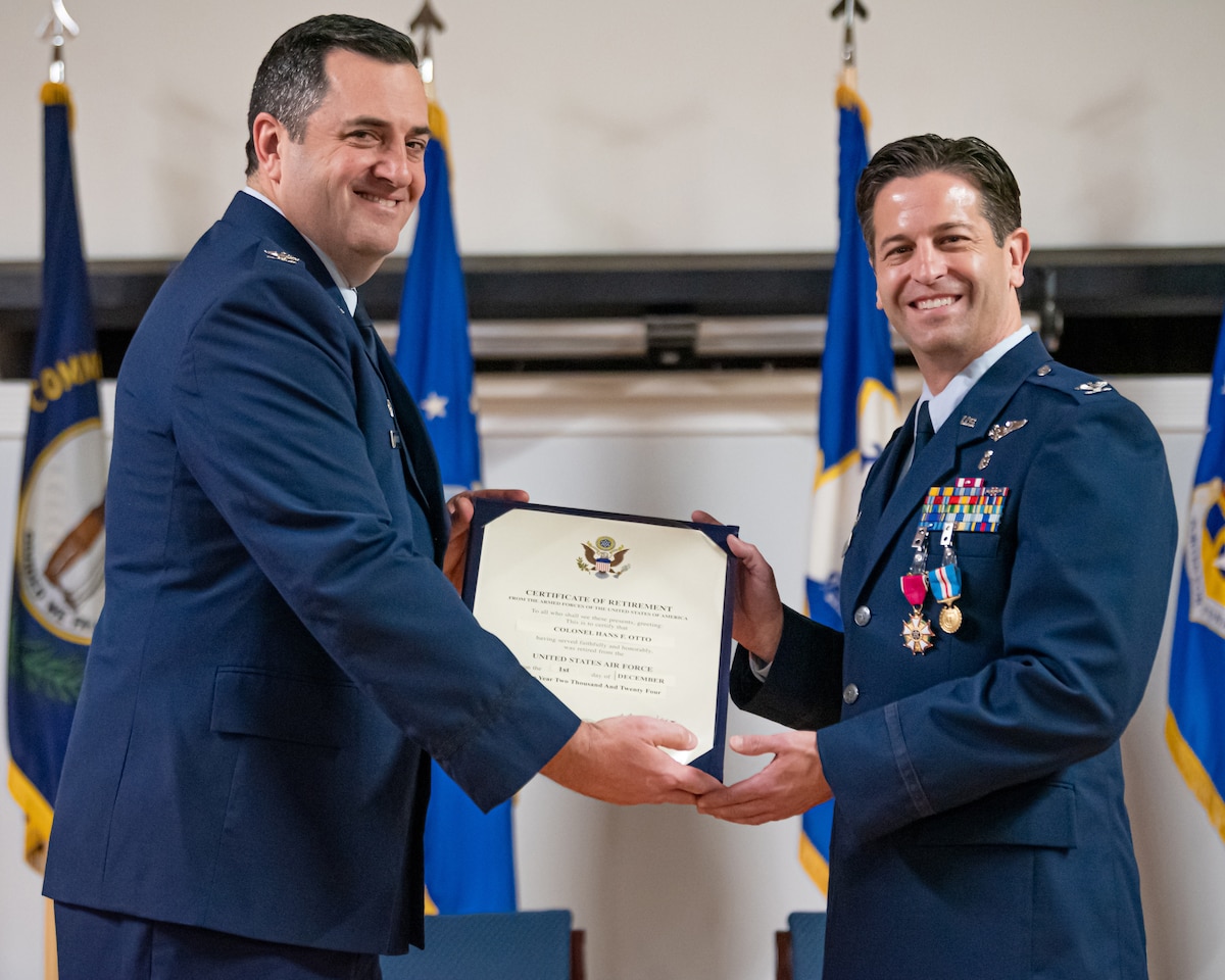 Col. Matthew Quenichet, left, commander of the 123rd Airlift Wing, presents Col. Hans Otto, outgoing commander of the 123rd Medical Group, with a Certificate of Retirement during a ceremony at the Kentucky Air National Guard Base in Louisville, Ky., Dec. 15, 2024. Otto’s career spanned 27 years across multiple assignments in the active-duty Air Force, Air Force Reserve and Air National Guard. (U.S. Air National Guard photo by Tech. Sgt. Chloe Ochs)