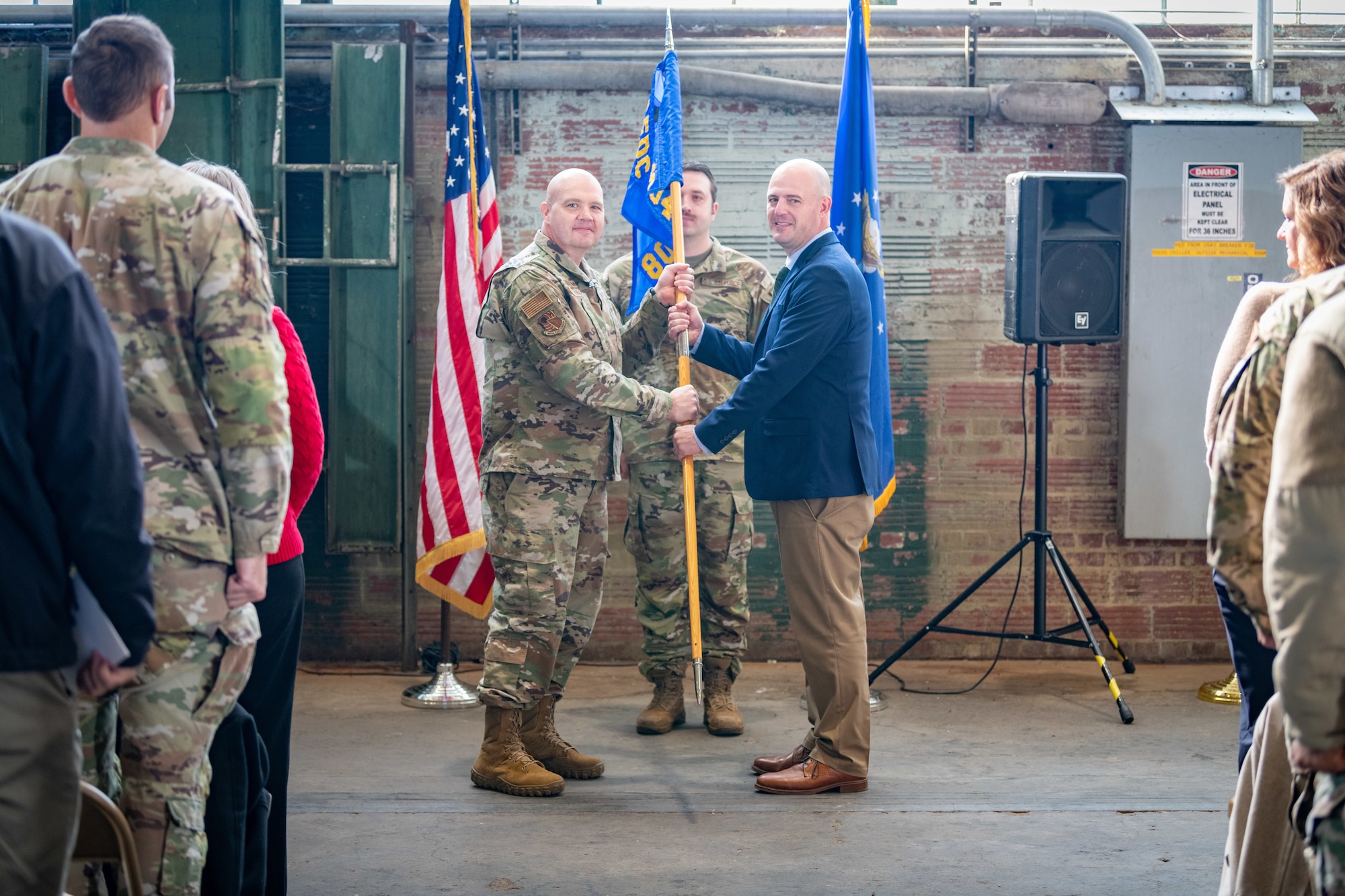 Dustin Boss, right, takes the guidon from Arnold Engineering Development Complex 804th Test Group Commander Col. Jason Vap, to assume leadership of the AEDC 804th Test Support Squadron during an Assumption of Leadership ceremony Dec. 2, 2024, at Arnold Air Force Base, Tenn., headquarters of AEDC. (U.S. Air Force photo by Keith Thornburgh)