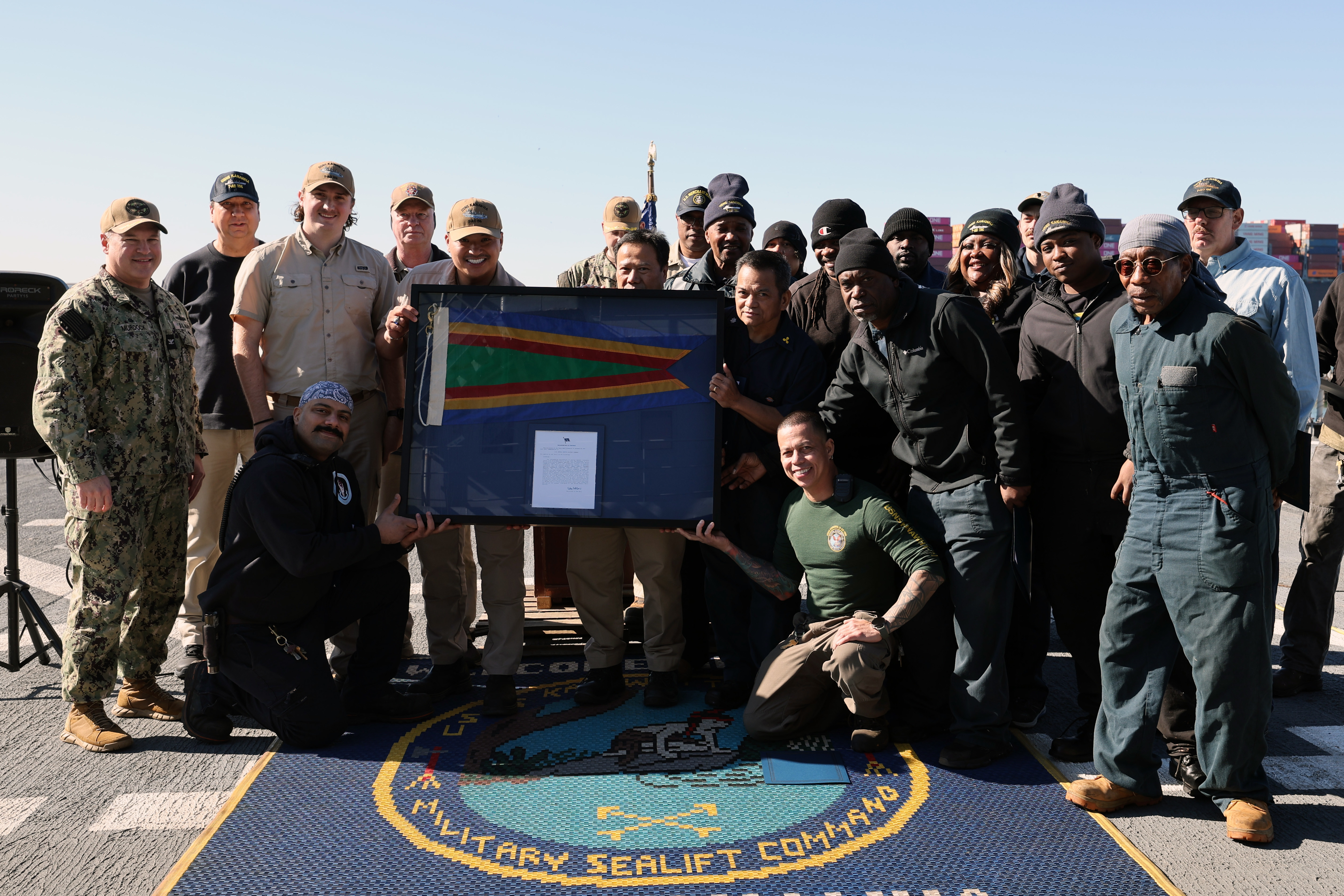 Civil Service Mariners who crew Military Sealift Command's fleet replenishment oiler USNS Kanawha (T-AO 196) pose for a group photo after the ship was awarded the Navy Unit Commendation while the vessel was pier-side on Naval Station Norfolk, Feb. 7. The crew earned the NUC for their efforts while deployed to U.S. Central Command.