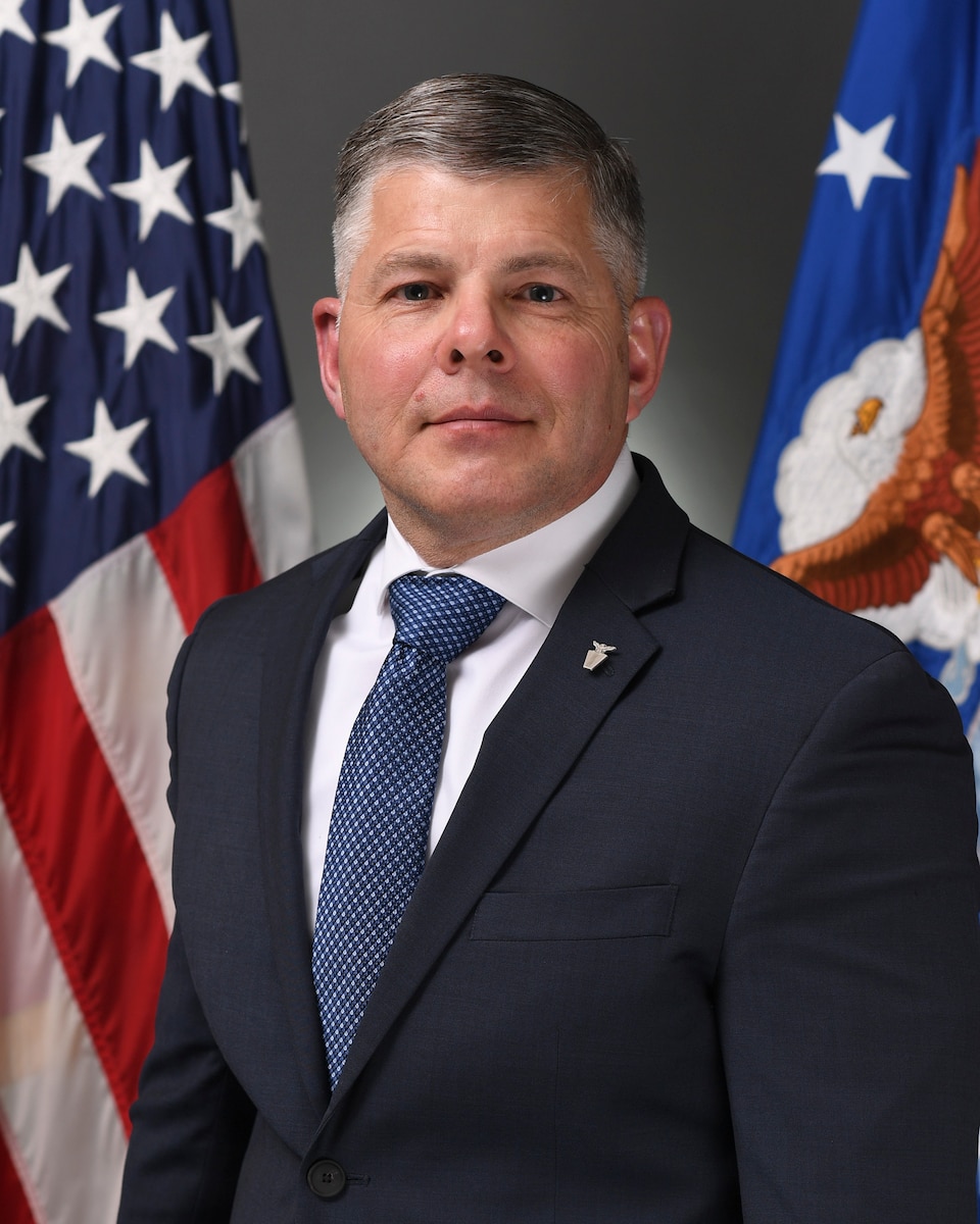 A civilian stands for a portrait.