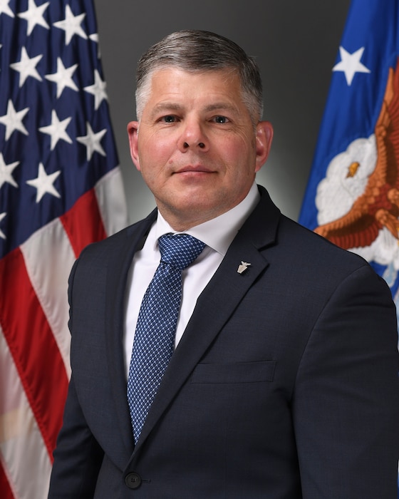 A civilian stands for a portrait.