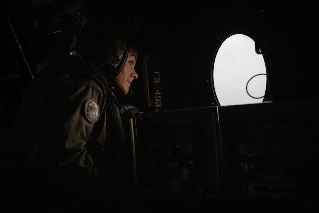 U.S. Marine Corps Gunnery Sgt. Jami Pitcock, a crew chief with Marine Medium Tiltrotor Squadron (VMM) 774, Marine Aircraft Group 49, 4th Marine Aircraft Wing, looks out the window of an MV-22B Osprey, tiltrotor aircraft, Naval Air Station Joint Reserve Base New Orleans, Belle Chasse, Louisiana, Feb. 9, 2025. The Marine Corps is the lead service for Super Bowl LIX flyover, participating in multiple events throughout the week exhibiting pride leading up to the U.S. Marine Corps 250th birthday. (U.S. Marine Corps photo by Sgt. Scott Jenkins)