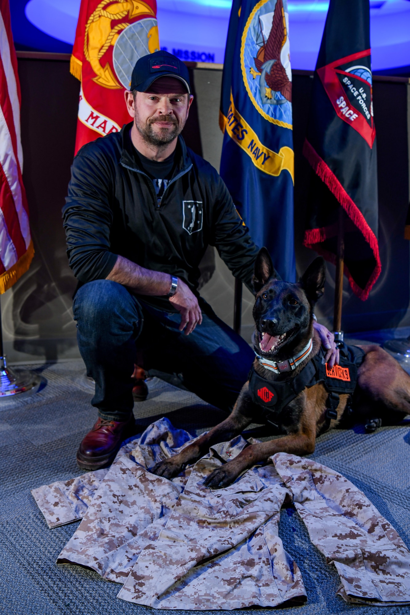 Man and dog pose for a photo