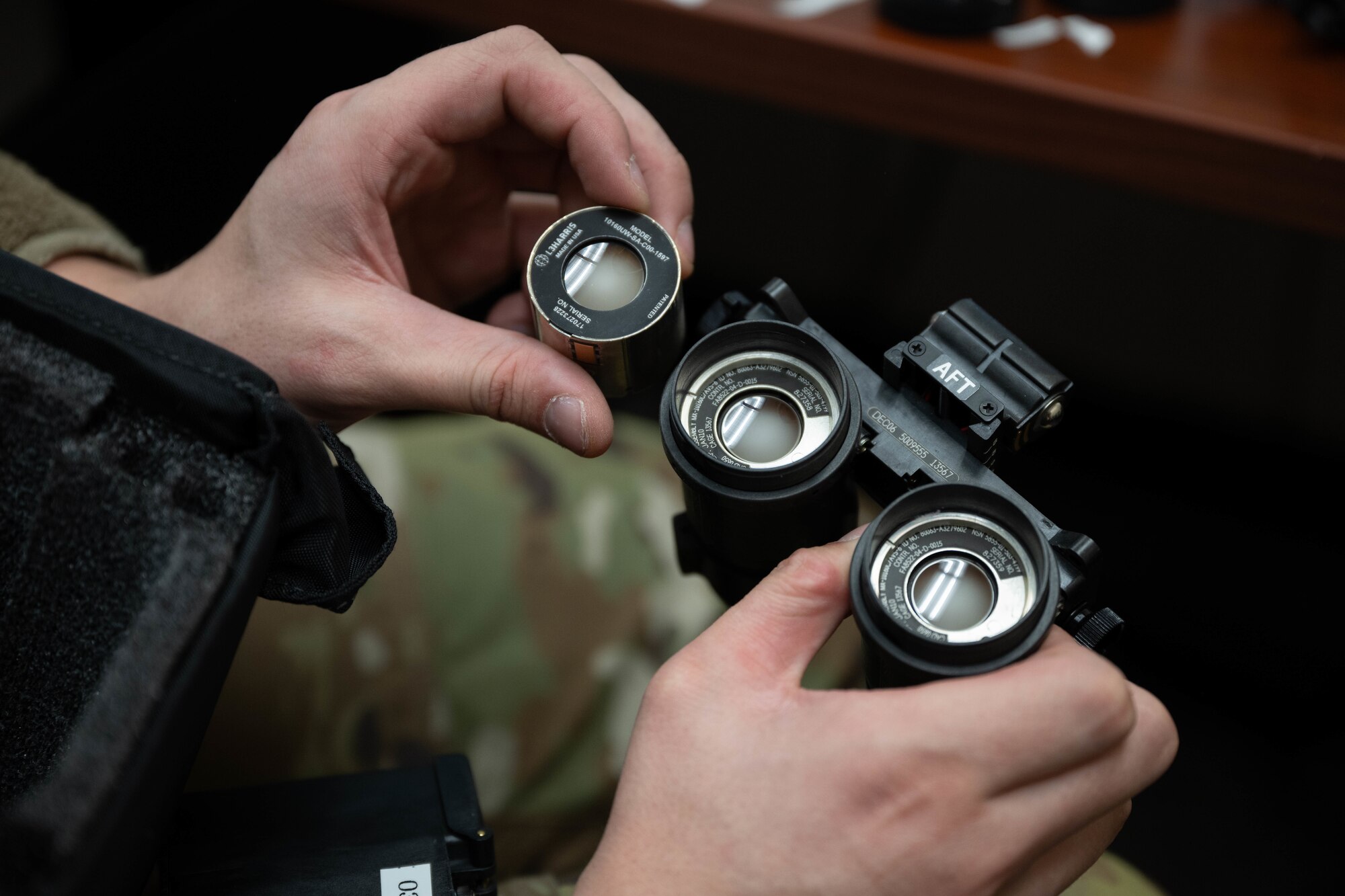 U.S. Air Force Senior Airman Lucas Dacosta, 305th Operations Support Squadron Aircrew Flight Equipment journeyman, inspects image intensifier tubes at Joint Base McGuire-Dix-Lakehurst, N.J., Feb. 5, 2025. AFE specialists perform routine maintenance on regularly used items such as helmets and oxygen masks. (U.S. Air Force photo by Senior Airman Aidan Thompson)