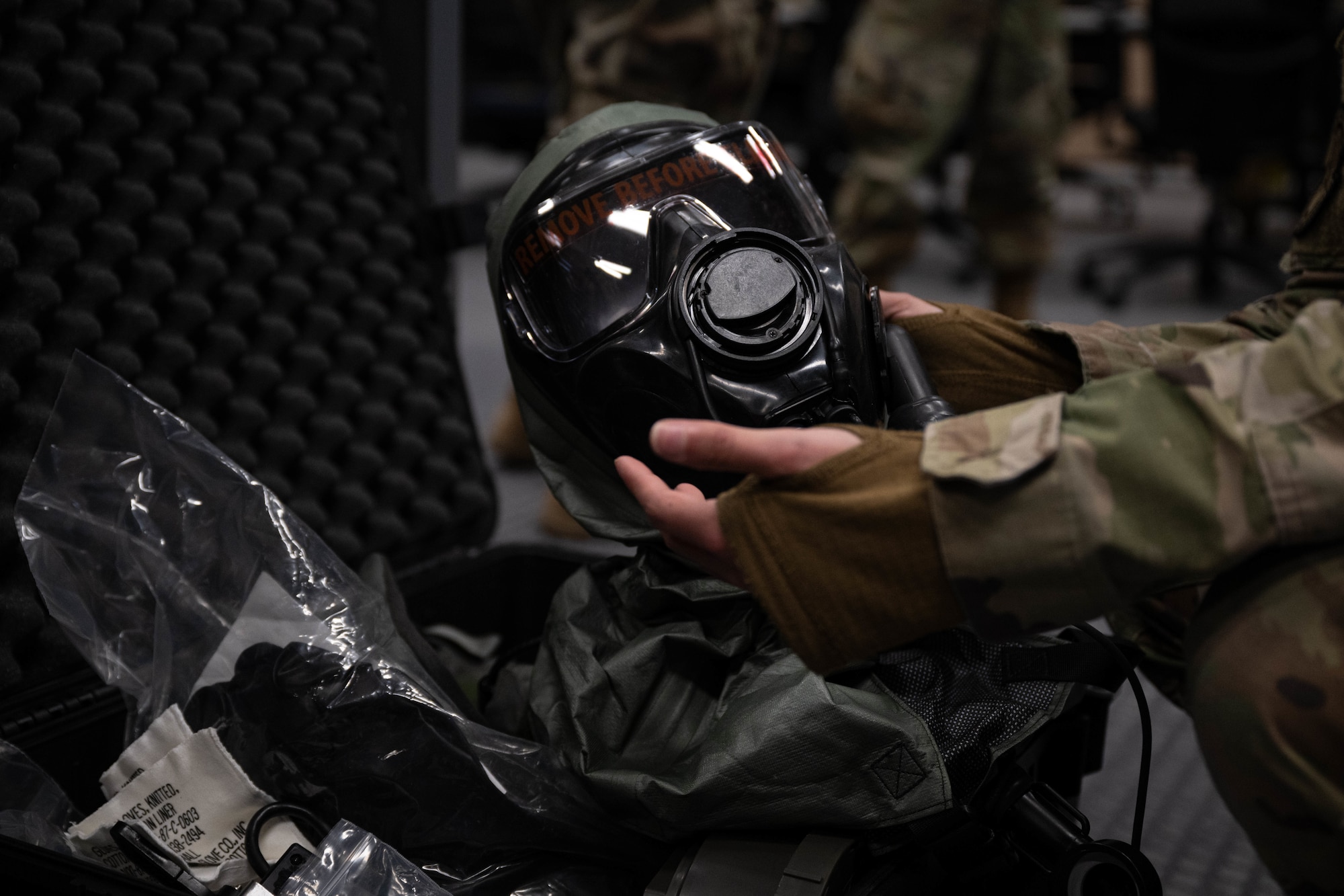 U.S. Air Force Senior Airman Lacey Hoadley, 305th Operations Support Squadron Aircrew Flight Equipment journeyman, inspects an M69 Joint Service Aircrew Mask at Joint Base McGuire-Dix-Lakehurst, N.J., Feb. 5, 2025. AFE specialists perform routine maintenance on regularly used items such as helmets and chemical masks. (U.S. Air Force photo by Senior Airman Aidan Thompson)