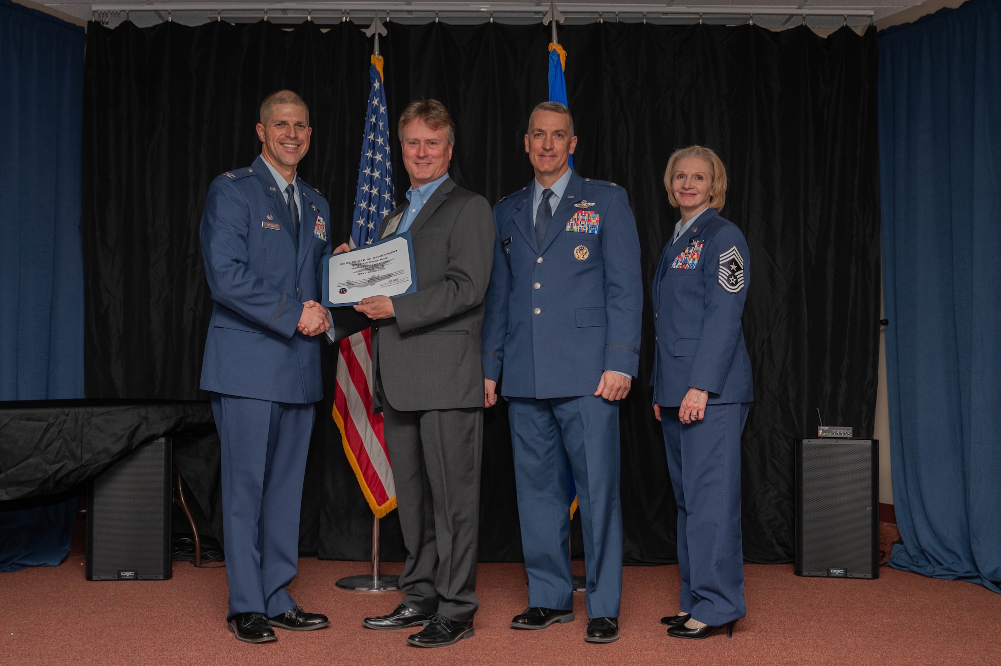 The 7th Bomb Wing leadership team presents a certificate to Gray Bridwell, 7th BW honorary commander and Abilene Chamber of Commerce Military Affairs Committee vice president, during the honorary commander induction ceremony at Dyess Air Force Base, Texas, Feb. 7, 2025. The program aims to forge a mutually beneficial relationship between influential community members and Dyess Airmen that lasts beyond their term as honorary commanders. (U.S. Air Force photo by Senior Airman Alondra Cristobal Hernandez)