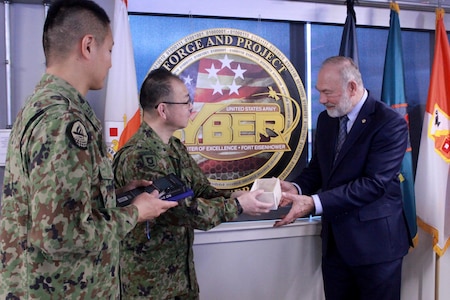 Commandant of the Japan Ground Self Defense Force Signal School, Maj. Gen. Shinichi Naraoka, presented Deputy to the Commanding General, Mr. Robert Kazimer a token of appreciation for the CCoE's assistance in developing the cyber workforce in the JGSDF.