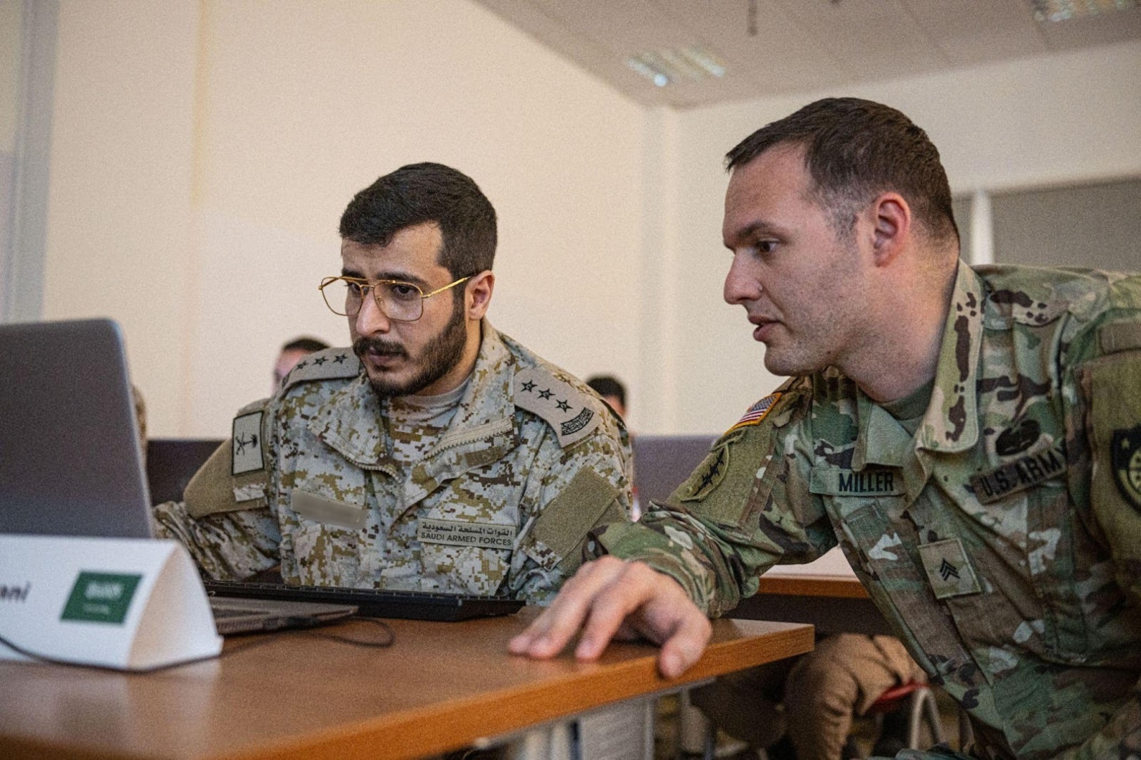 A U.S. Army and a Kingdom of Saudi Arabia service member collaborate to solve a framework issue during a cyber security training at Exercise Eagle Resolve 2025 (ER25) within the U.S. Central Command area of responsibility on Jan. 14, 2025. Service members from GCC nations gathered for Eagle Resolve 2025 to plan and execute crisis management and crisis response operations directly supporting military efforts in a joint-combined environment. (U.S. Air Force photo by Senior Airman Sir Wyrick)