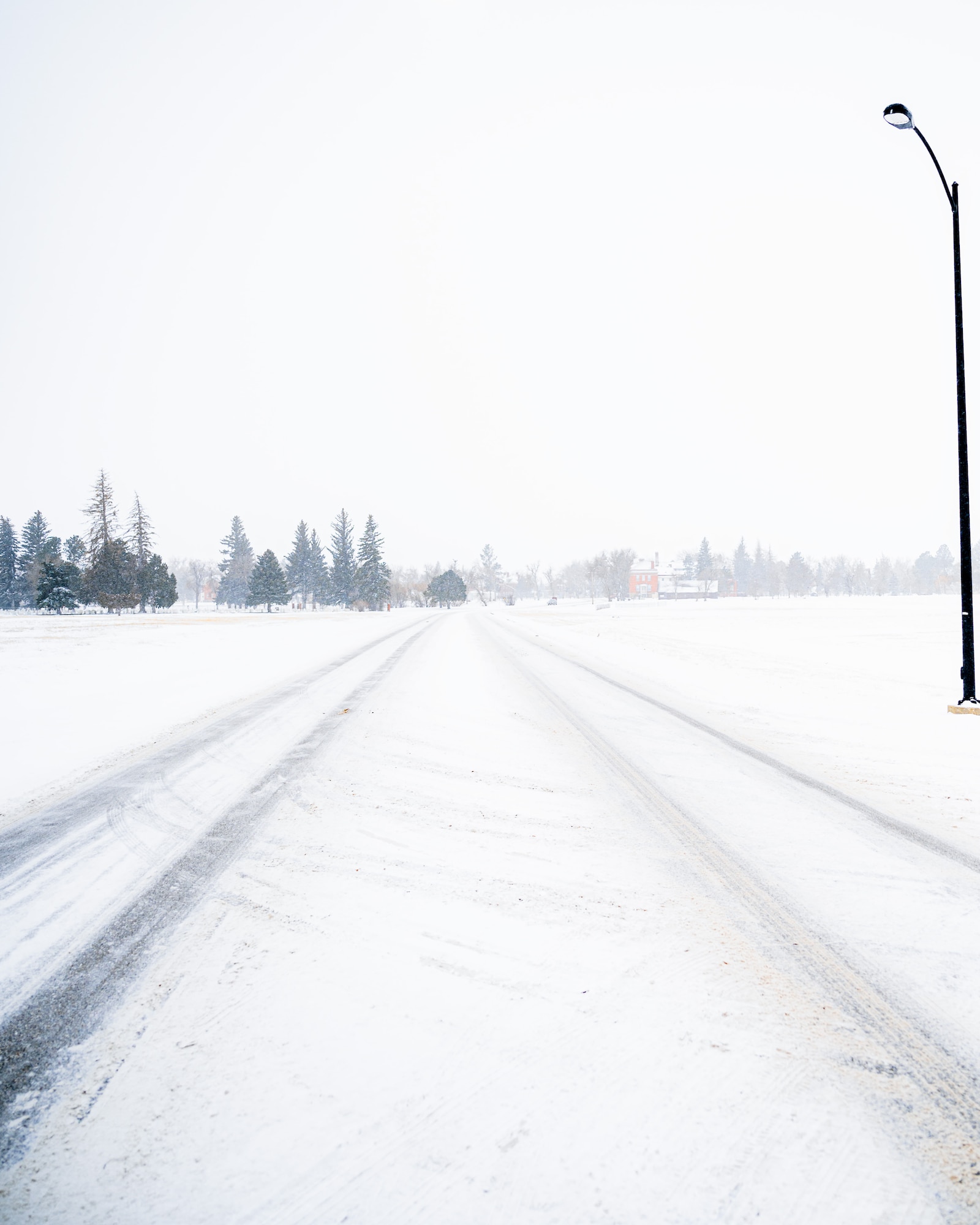 A road before 90th Civil Engineer Horizontal Repair Shop Airmen cleared snow from it at F.E. Warren Air Force Base, Wyoming, Jan. 25, 2025. From early morning hours to late at night, the 90 CES Horizontal Repair Shop, also known as the ‘Dirt Boyz’, work tirelessly to clear hazardous winter conditions, ensuring maintainers, security forces, and essential personnel can safely reach the missile field to sustain 24/7 operations. (U.S. Air Force photo by Staff Sgt. Michael A. Richmond)