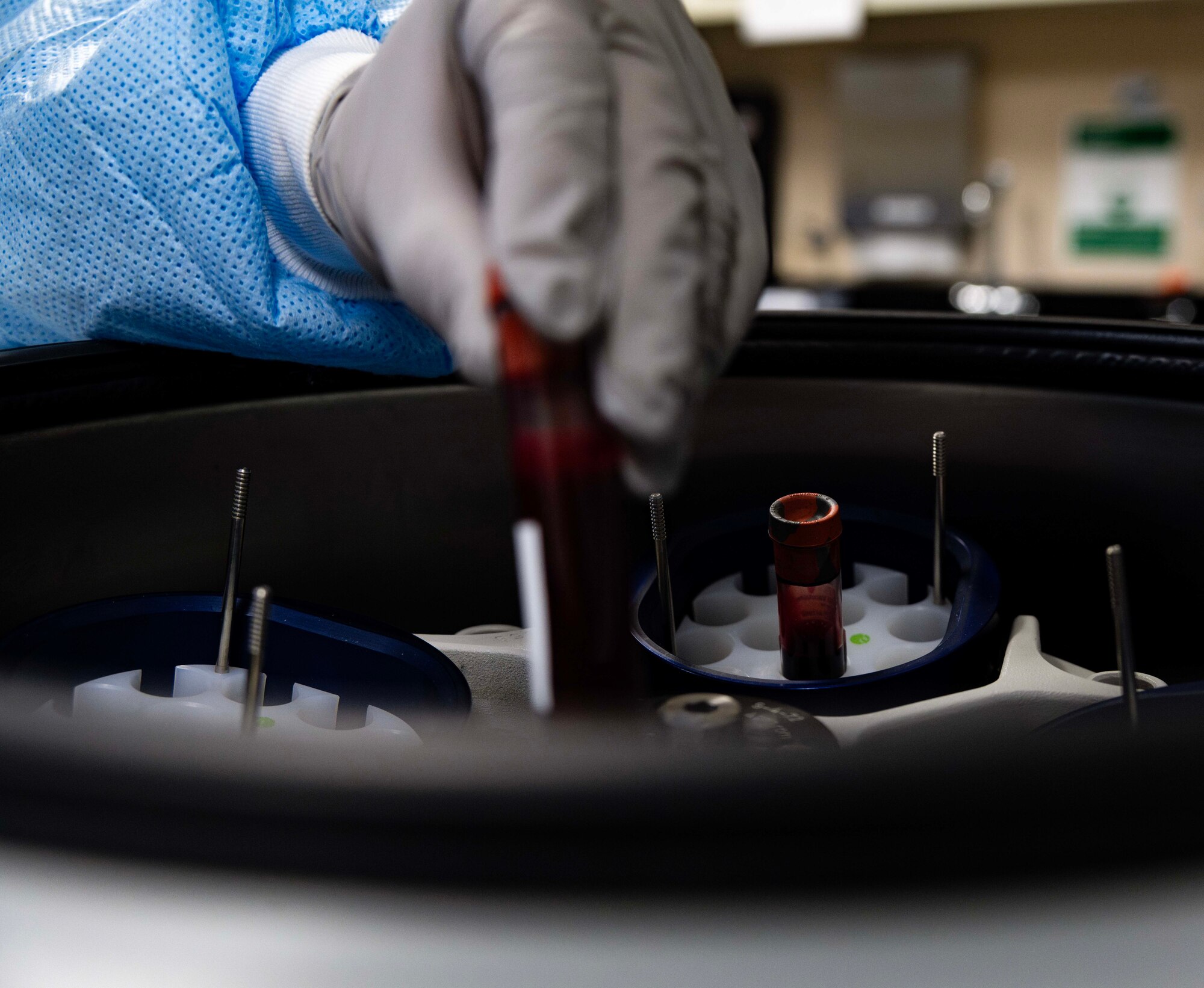Luisa Rodriguez, 5th Medical Operations Squadron laboratory technician, places blood specimens in a centrifuge at Minot Air Force Base, North Dakota, Jan. 29, 2025. The centrifuge allows technicians to separate and analyze blood components quickly and accurately. (U.S. Air Force photo by Senior Airman Alyssa Bankston)