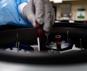 Luisa Rodriguez, 5th Medical Operations Squadron laboratory technician, places blood specimens in a centrifuge at Minot Air Force Base, North Dakota, Jan. 29, 2025. The centrifuge allows technicians to separate and analyze blood components quickly and accurately. (U.S. Air Force photo by Senior Airman Alyssa Bankston)