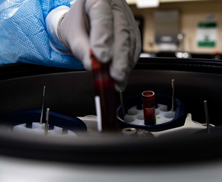 Luisa Rodriguez, 5th Medical Operations Squadron laboratory technician, places blood specimens in a centrifuge at Minot Air Force Base, North Dakota, Jan. 29, 2025. The centrifuge allows technicians to separate and analyze blood components quickly and accurately. (U.S. Air Force photo by Senior Airman Alyssa Bankston)