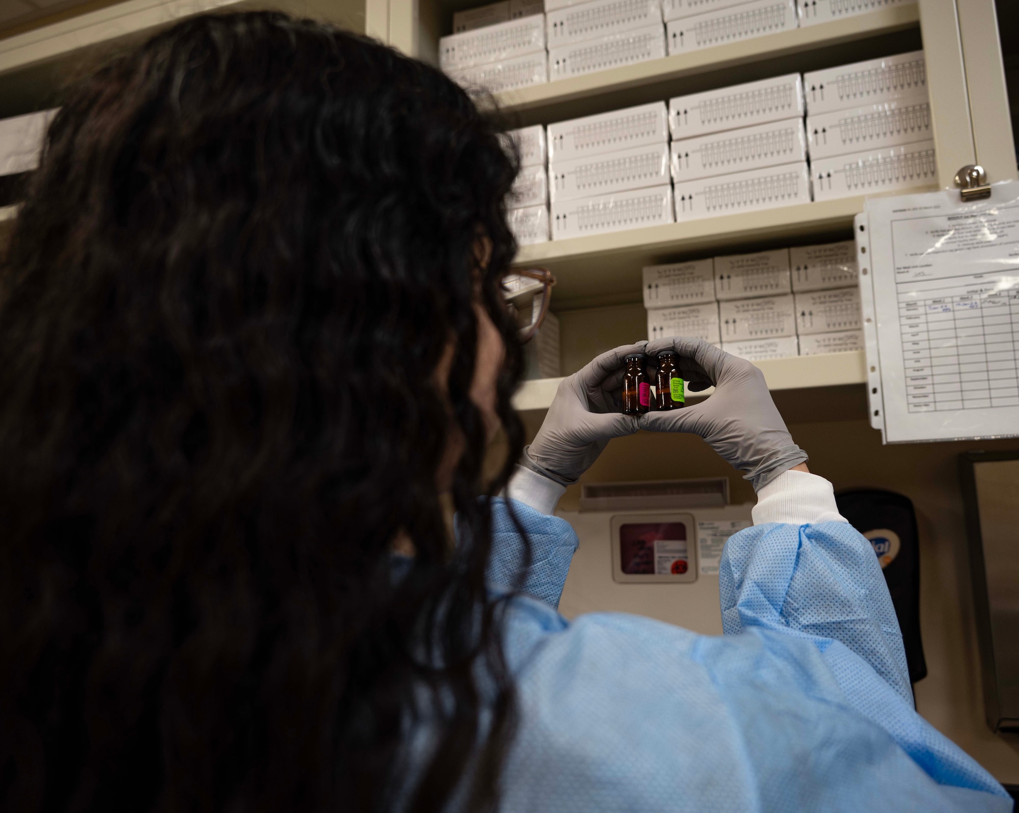 Luisa Rodriguez, 5th Medical Operations Squadron laboratory technician, inspects chemistry quality control material at Minot Air Force Base, North Dakota, Jan. 29, 2025. Chemistry quality control is conducted to prevent defective products from reaching the customer. (U.S. Air Force photo by Senior Airman Alyssa Bankston)