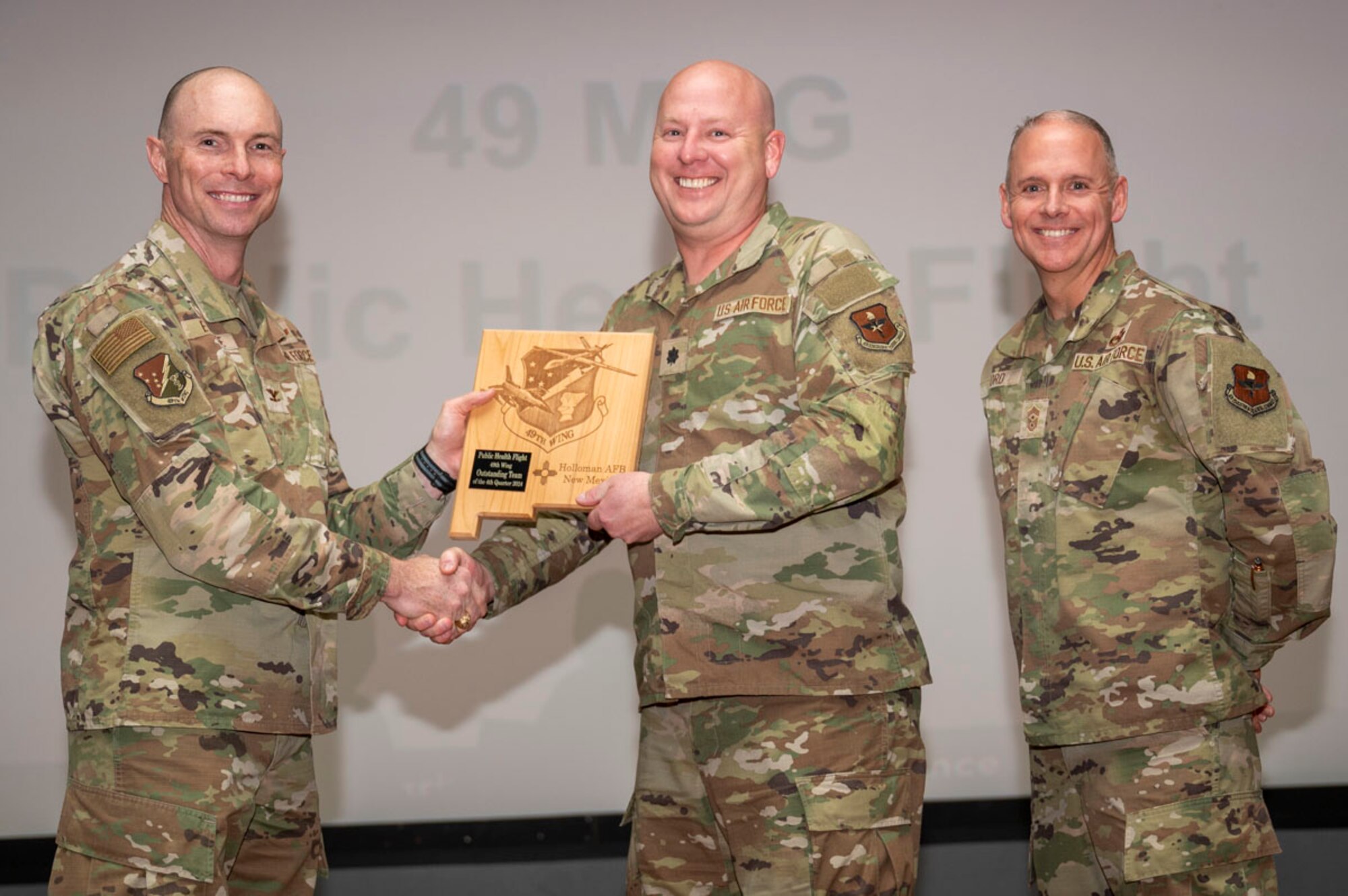 U.S. Air Force Lt. Col. Timothy Davis, 49th Operational Medical Readiness Public Health commander, accepts the 49th Wing’s Outstanding Team of the Quarter Award, during the 49th Wing’s 4th Quarter Award ceremony at Holloman Air Force Base, New Mexico, Feb. 7, 2025. Quarterly award winners were selected based on their technical expertise, demonstration of leadership and job performance. (U.S. Air Force photo by Senior Airman Michelle Ferrari)