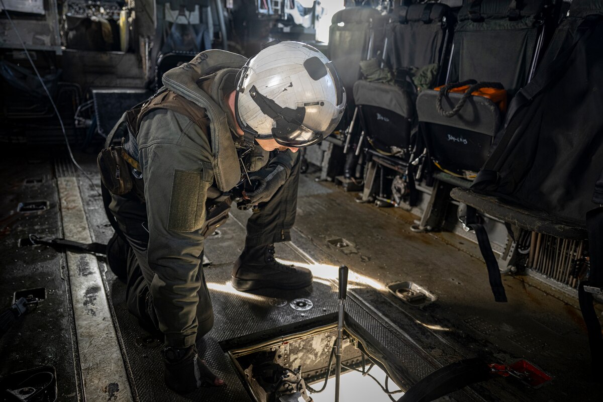 Crew chief looks out helicopter window