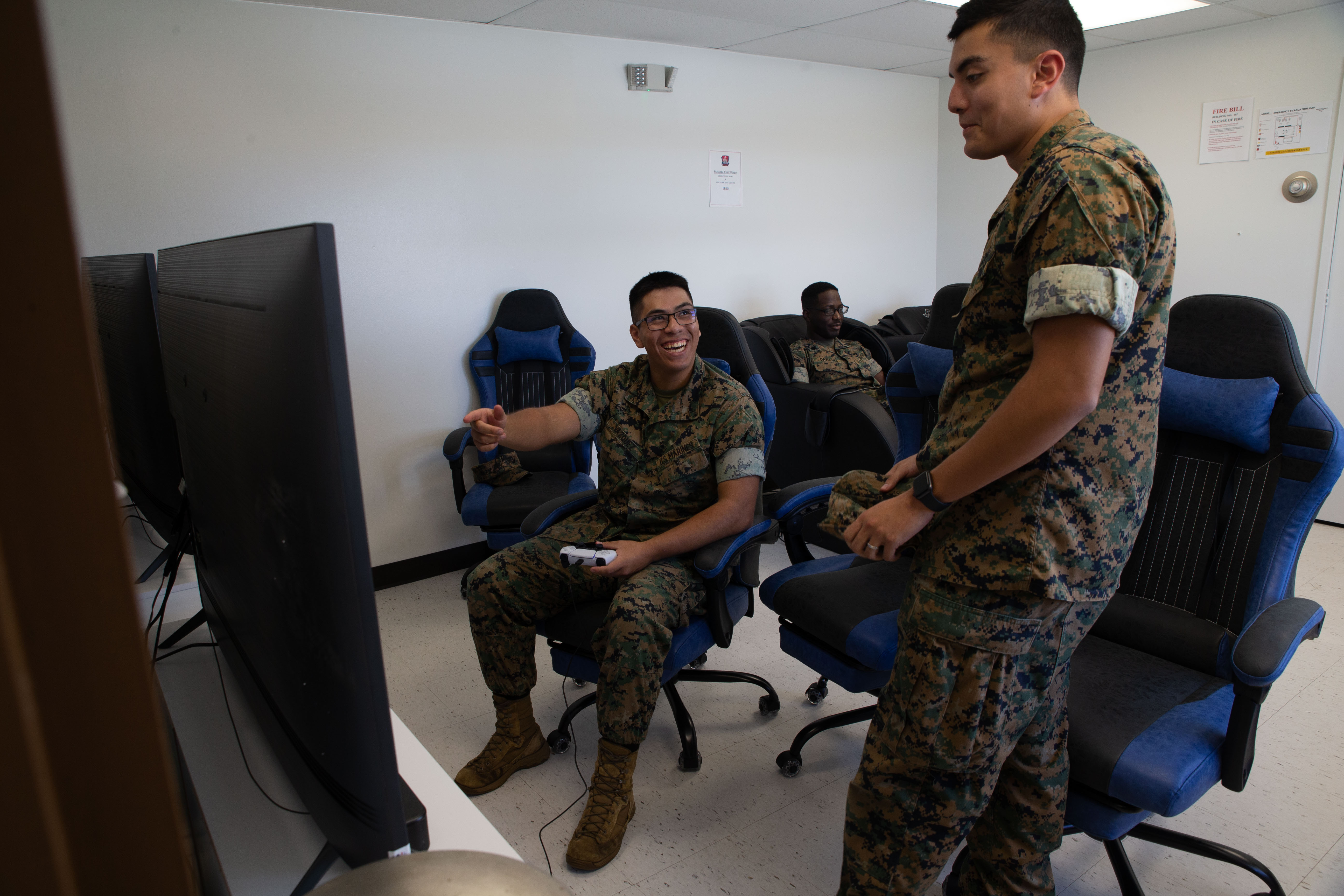 U.S. Marine Corps Pfc. Alexis Vasquez, small arms repair technician, Headquarters Company, Marine Corps Base Camp Blaz, and Lance Cpl. Cesar Gutierrez, operations specialist, Headquarters Company, MCB Camp Blaz, enjoy the amenities provided at the newly opened Single Marine Program center, on MCB Camp Blaz, Guam, Jan. 31, 2025. MCB Camp Blaz opened the SMP center to help improve the quality of life for single Marines and Sailors stationed in Guam. (U.S. Marine Corps photo by Lance Cpl. Afton Smiley)
