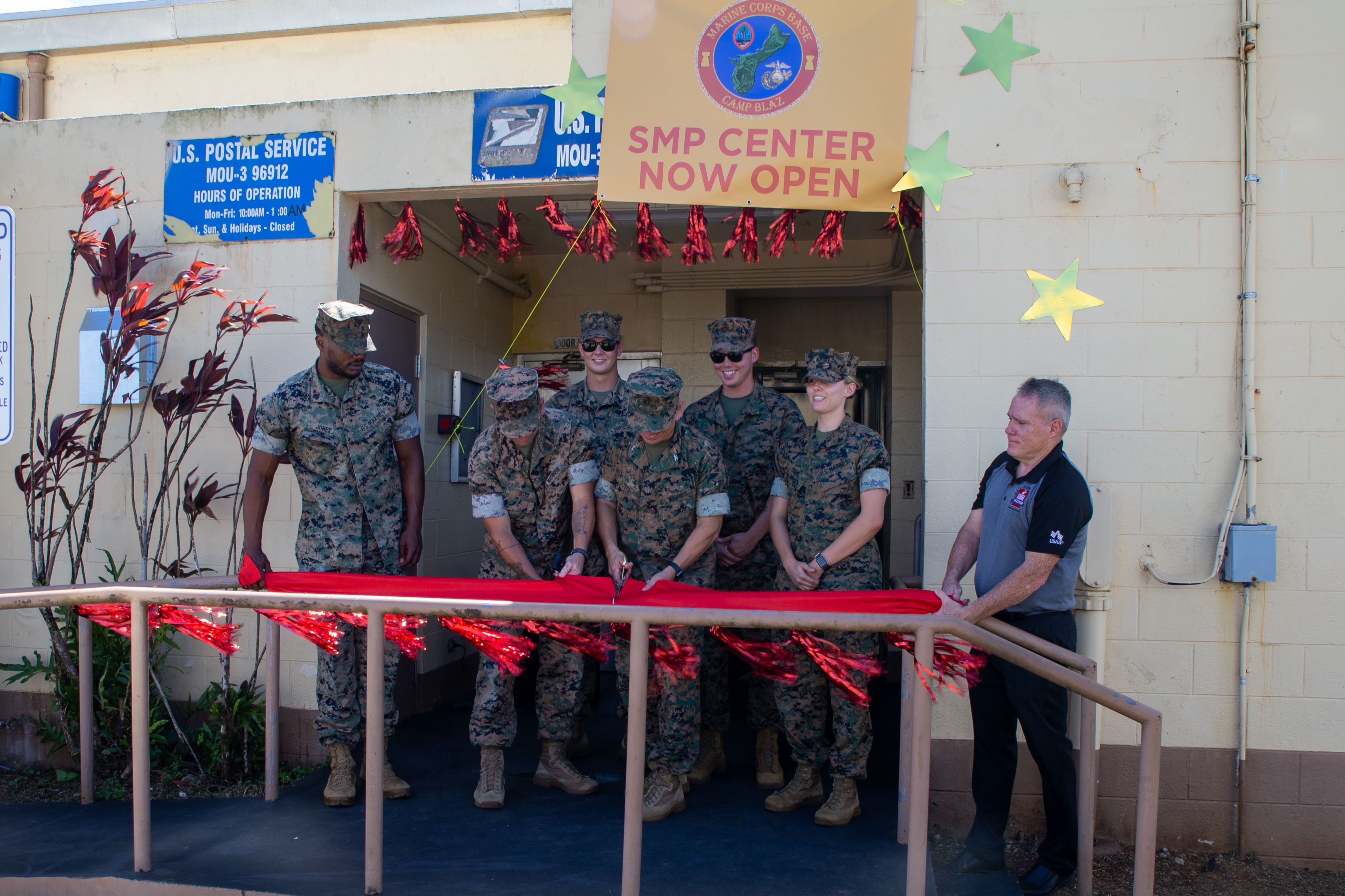 U.S. Marines with Marine Corps Base Camp Blaz, hold a ribbon cutting ceremony for the grand opening of the new Single Marine Program center on MCB Camp Blaz, Guam, Jan. 31, 2025. MCB Camp Blaz opened the SMP center to help improve the quality of life for single Marines and Sailors stationed in Guam. (U.S. Marine Corps photo by Lance Cpl. Afton Smiley)