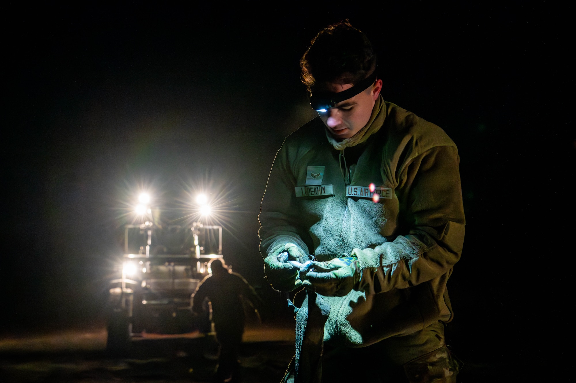 An airman begins the process of collecting dropped container delivery system bundles and heavy equipment.