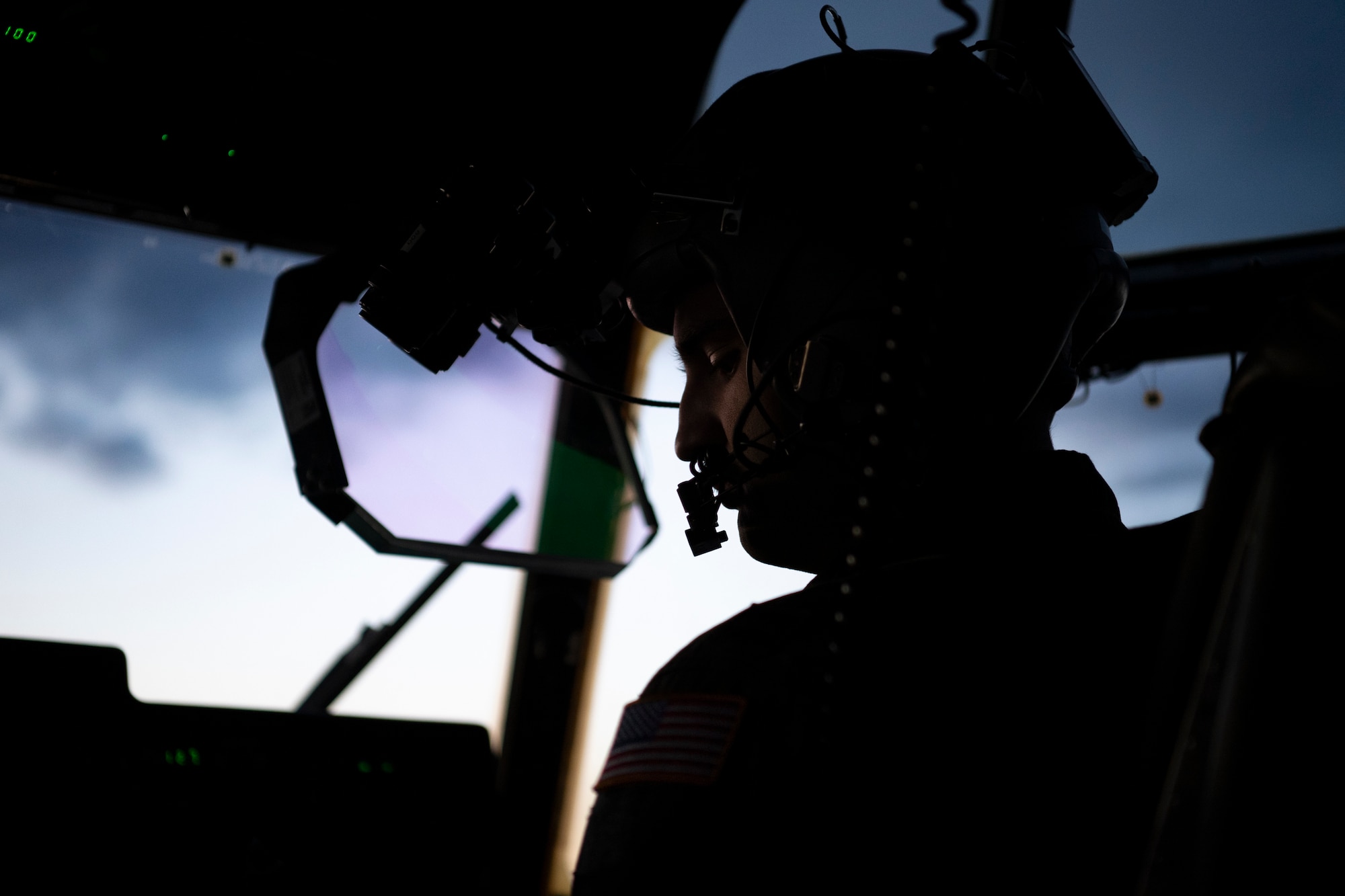 An airman performs a pre-flight check inside a C-130J Super Hercules cockpit