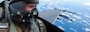 U.S. Air Force Airman 1st Class Thomas Hansford, Aerial Combat Camera Journeyman, assigned to the 1st Combat Camera Squadron, Joint Base Charleston, South Carolina, prepares to document a formation flight inside an F-16D Fighting Falcon over the U.S. Indo-Pacific Command area of responsibility, Feb. 7, 2025,