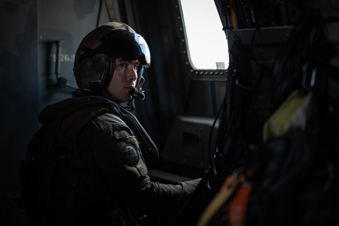 U.S. Marine Corps Staff Sgt. Nicholas Hutloff, a crew chief with Marine Medium Tiltrotor Squadron (VMM) 764, Marine Aircraft Group 41, 4th Marine Aircraft Wing, communicates to another crew chief, New Orleans, Feb. 7, 2025. The Marine Corps is the lead service for Super Bowl LIX flyover, participating in multiple events throughout the week exhibiting pride leading up to the U.S. Marine Corps 250th birthday. (U.S. Marine Corps photo by Sgt. Scott Jenkins)