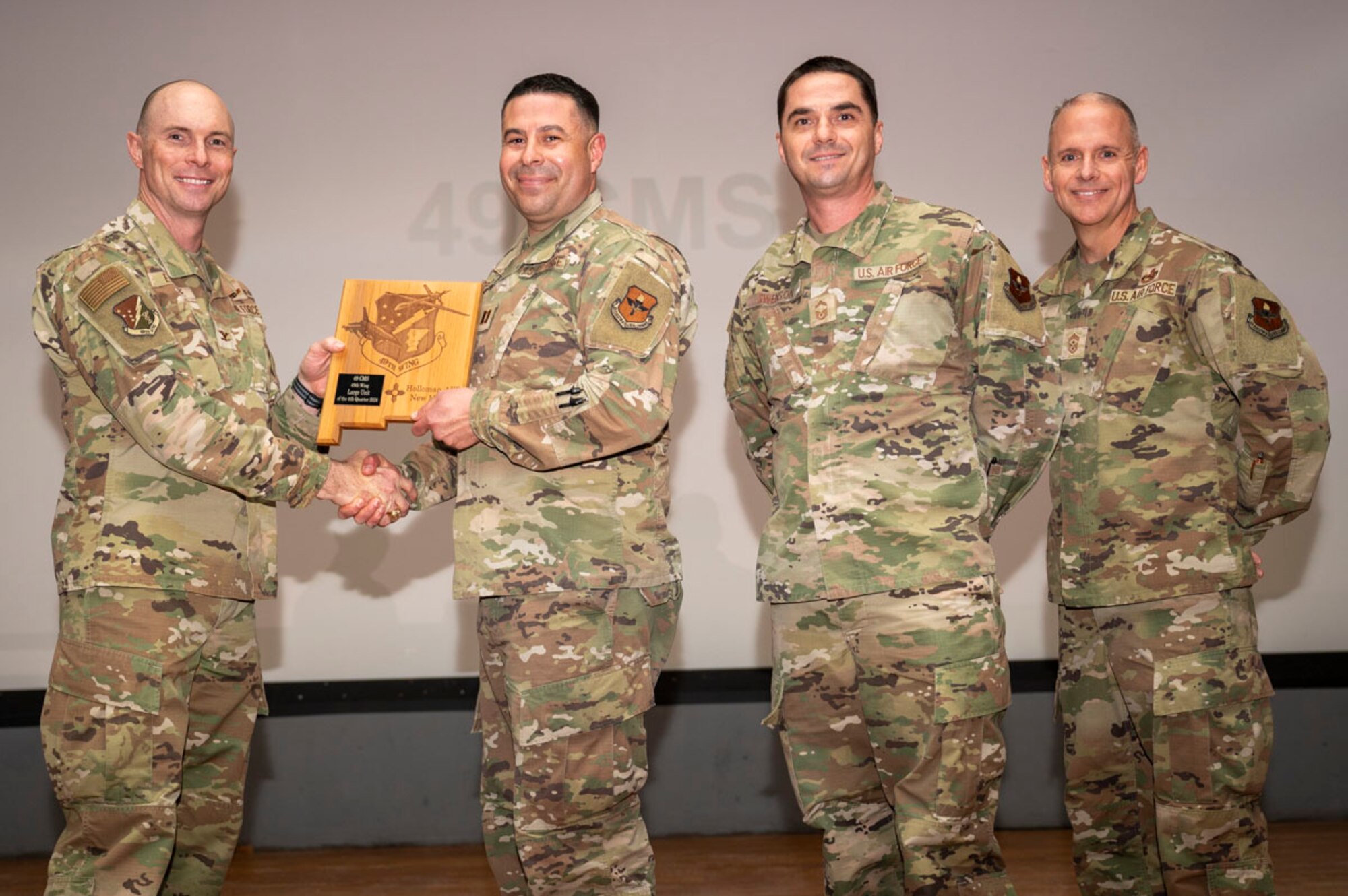U.S. Air Force Capt. Matthew Deluze, 49th Component Maintenance Squadron director of operations and U.S. Air Force Senior Master Sgt. Troy Swenson, 49th CMS maintenance superintendent, accepts the 49th Wing’s Large Unit of the Quarter Award, during the 49th Wing’s 4th Quarter Award ceremony at Holloman Air Force Base, New Mexico, Feb. 7, 2025. Quarterly award winners were selected based on their technical expertise, demonstration of leadership and job performance. (U.S. Air Force photo by Senior Airman Michelle Ferrari)