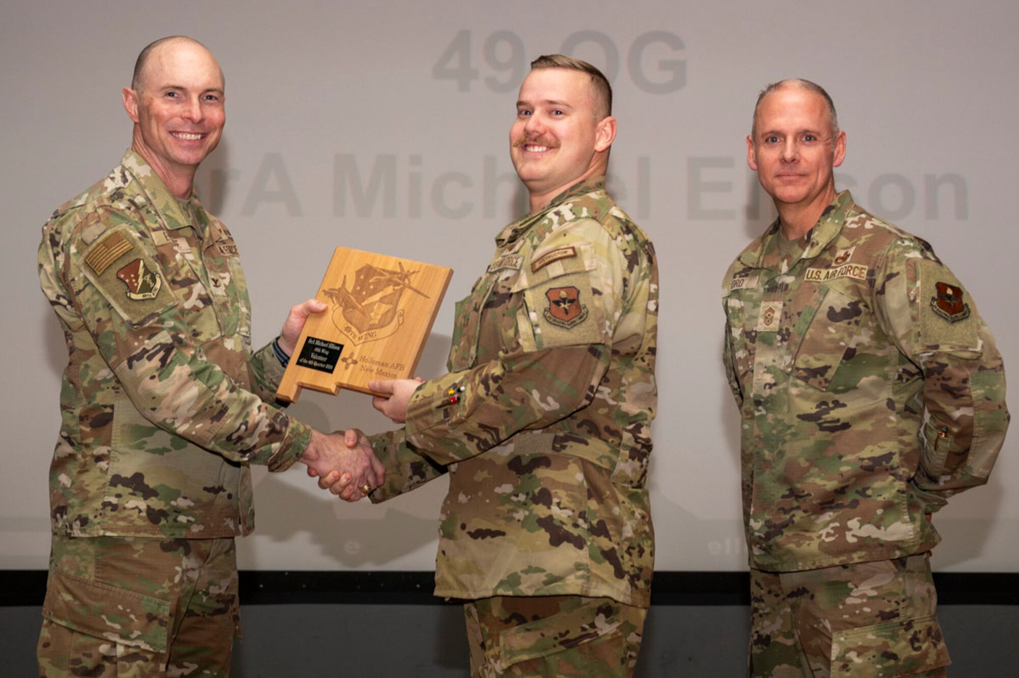 U.S. Air Force Senior Airman Michael Ellison,  29th Attack Squadron instructor sensor operator, accepts the 49th Wing’s Volunteer of the Fourth Quarter Award, during the 49th Wing’s 4th Quarter Award ceremony at Holloman Air Force Base, New Mexico, Feb. 7, 2025. Quarterly award winners were selected based on their technical expertise, demonstration of leadership and job performance. (U.S. Air Force photo by Senior Airman Michelle Ferrari)