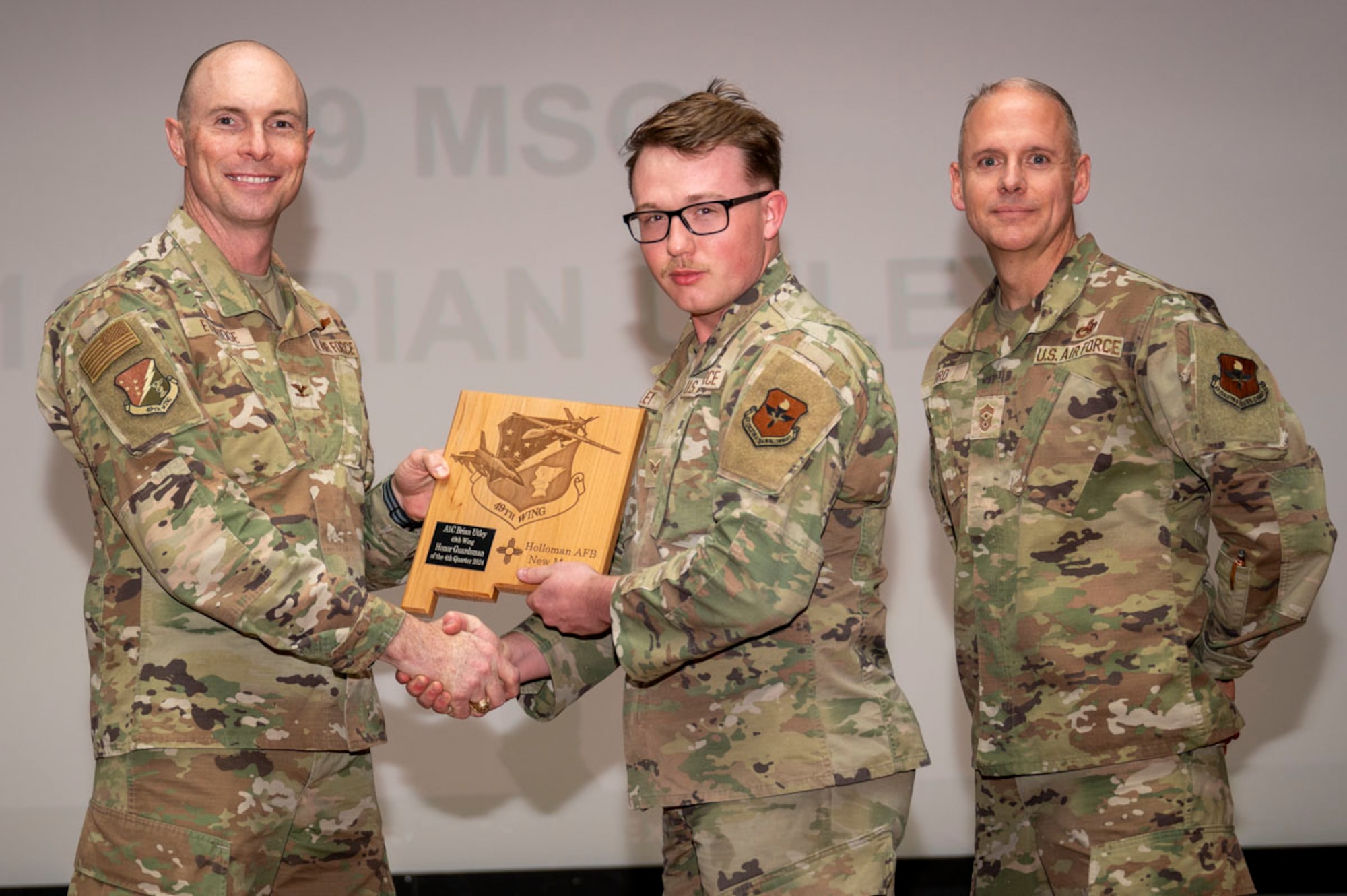 U.S. Air Force Senior Airman Brian Utley, 49th Aircraft Maintenance Squadron MQ-9 avionics technician, accepts the 49th Wing’s Honor Guardsman of the Quarter Award, during the 49th Wing’s 4th Quarter Award ceremony at Holloman Air Force Base, New Mexico, Feb. 7, 2025. Quarterly award winners were selected based on their technical expertise, demonstration of leadership and job performance. (U.S. Air Force photo by Senior Airman Michelle Ferrari)