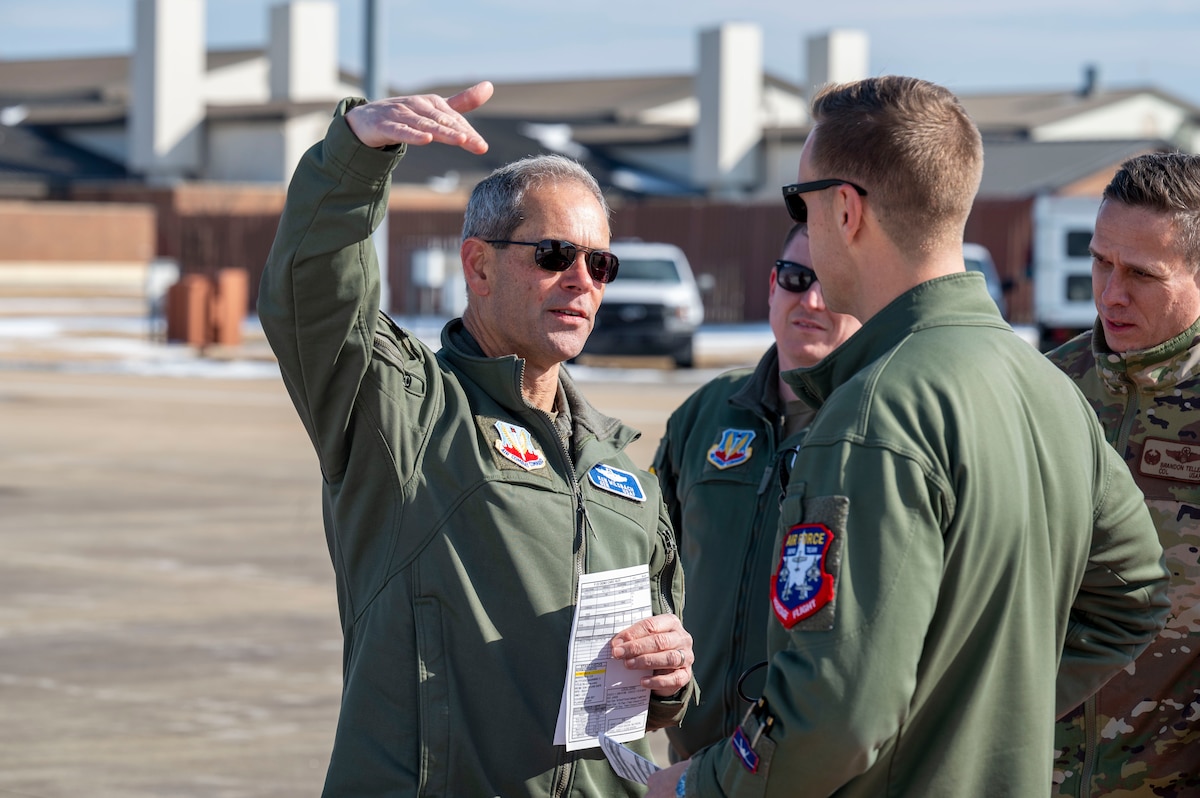 LANGLEY AIR FORCE BASE, Va--U.S. Air Force Gen. Ken Wilsbach, commander of Air Combat Command, speaks with Maj. Samuel “RaZZ” Larson following the team’s certification flight at Langley Air Force Base, Virginia, Jan. 24, 2025. The F-22 Demo Team is responsible for showcasing the unmatched maneuverability of the Air Force's fifth-generation air dominance stealth fighter at aerial shows around the globe. (U.S. Air Force photo by Tech Sgt. Matthew Coleman-Foster)