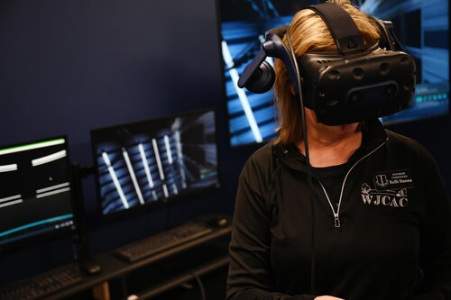 Kelli Hanna, 17th Training Wing Honorary Commander, interacts with virtual reality training equipment at the 17th Training Support Squadron’s Instructional Technology during their 17th Training Group immersion, Goodfellow Air Force Base, Texas, Feb. 6, 2025. The ITU demonstrated how instructors can effectively train students while ensuring they receive hands-on experience before entering the operational field. (U.S. Air Force photo by Senior Airman Madi Collier)