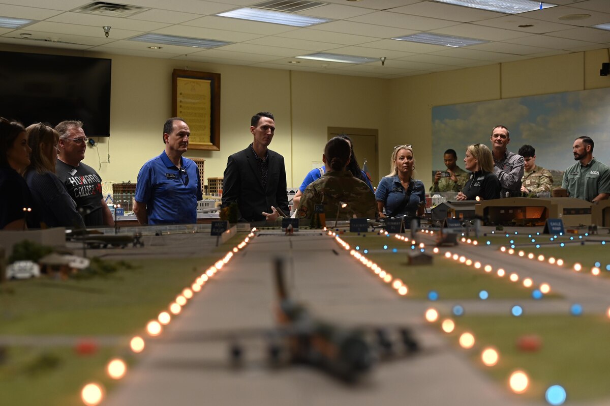 The 17th Training Wing Honorary Commanders learn about the history of the Norma Brown trainer at the Louis F. Garland Department of Defense Fire Academy during their 17th Training Group immersion, Goodfellow Air Force Base, Texas, Feb. 6, 2025. The 1979-era tabletop model is used to assist in training fire protection specialists in the Fire Officer II and III courses at the Louis F. Garland Department of Defense Fire Academy. (U.S. Air Force photo by Senior Airman Madi Collier)