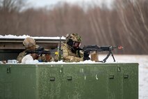 Airmen aim their weapons