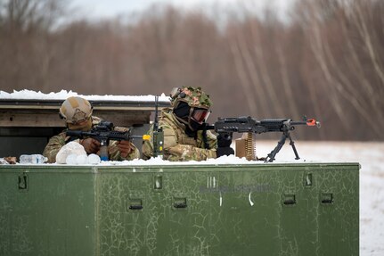 Airmen aim their weapons